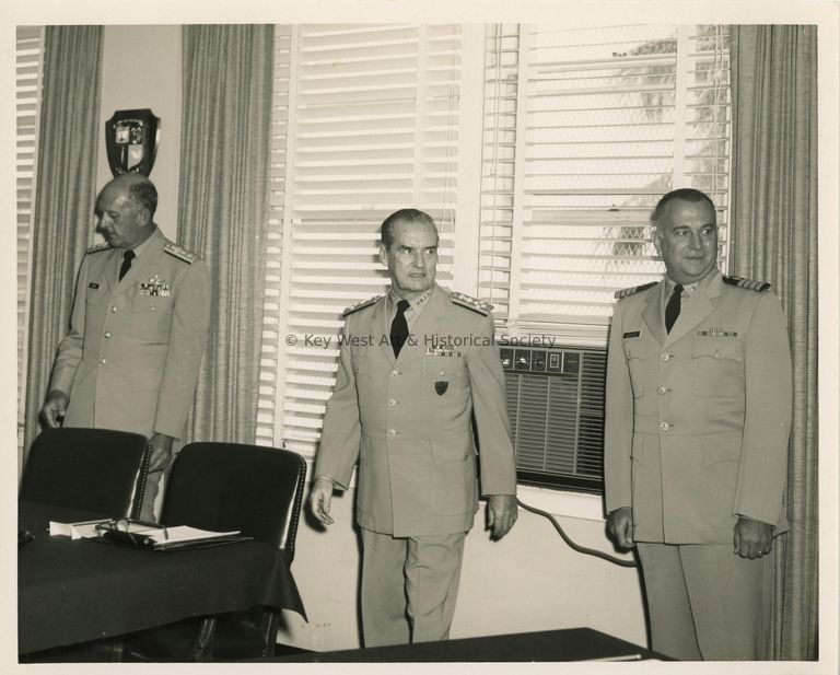 3 Men in uniform in an office