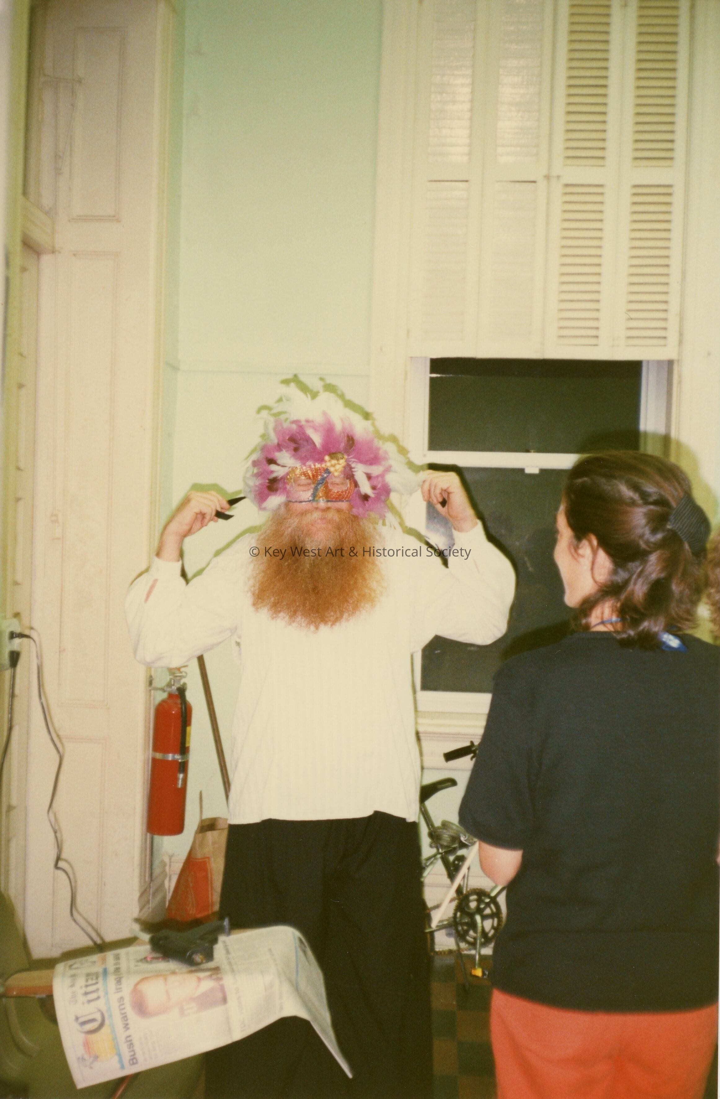 An unknown man trying on a face mask.