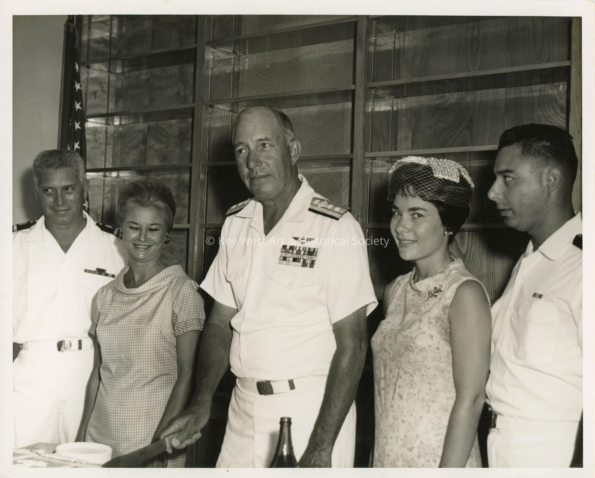 A group of unknown people at a party, a few in uniform