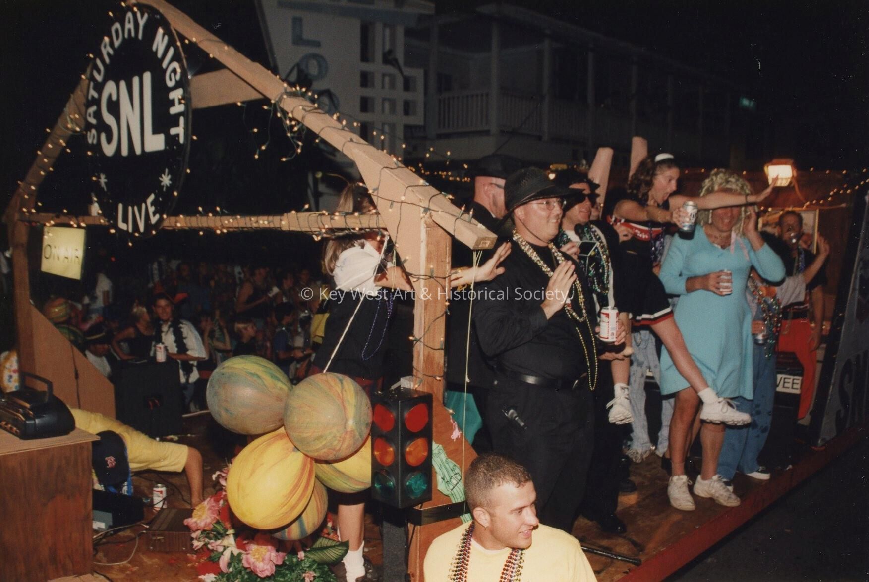 A float in the parade that reads Saturday night live.