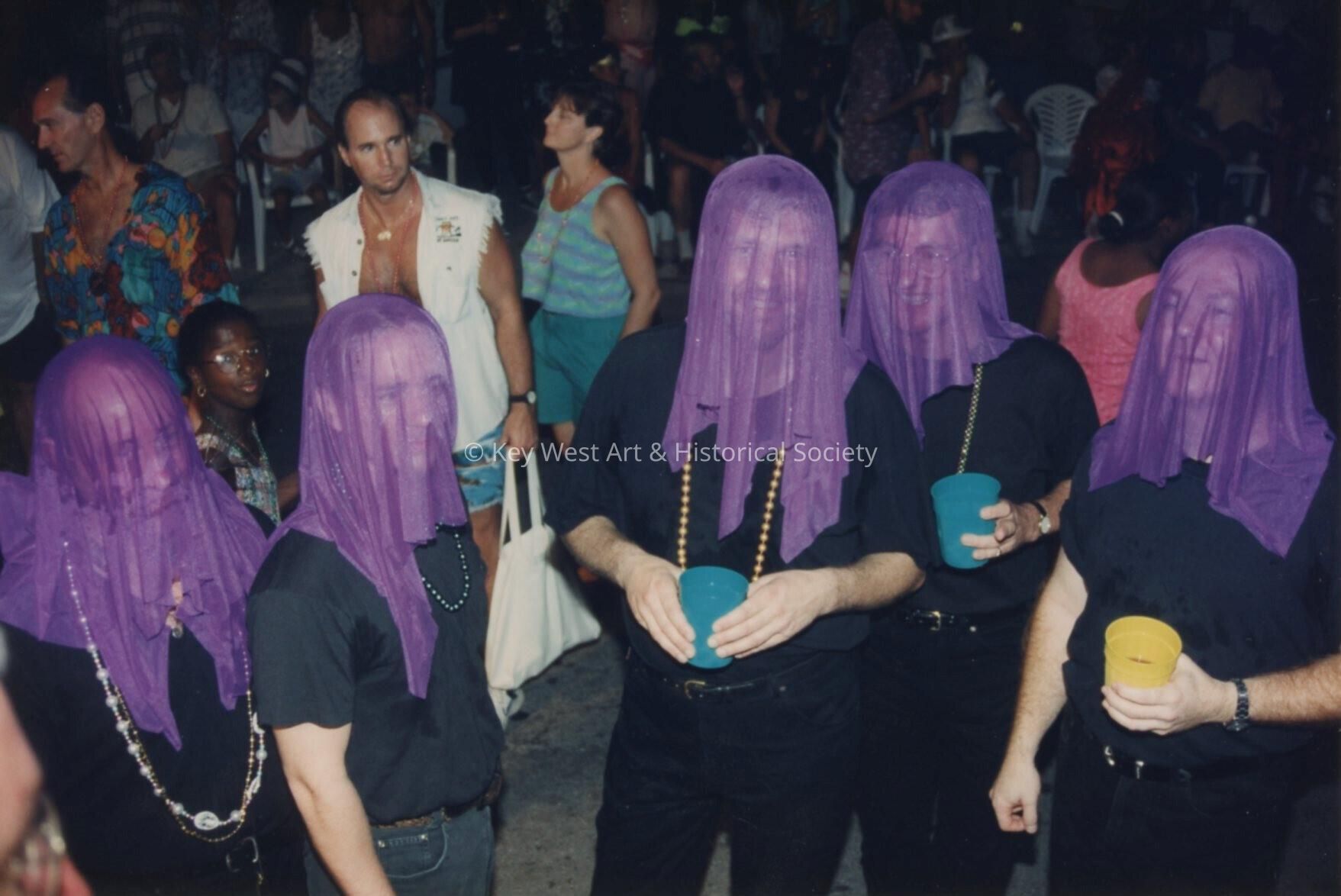 A group of unknown people dressed up.