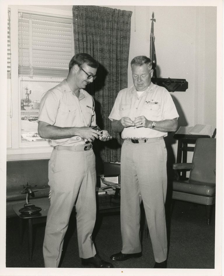 2 Men in uniform in an office