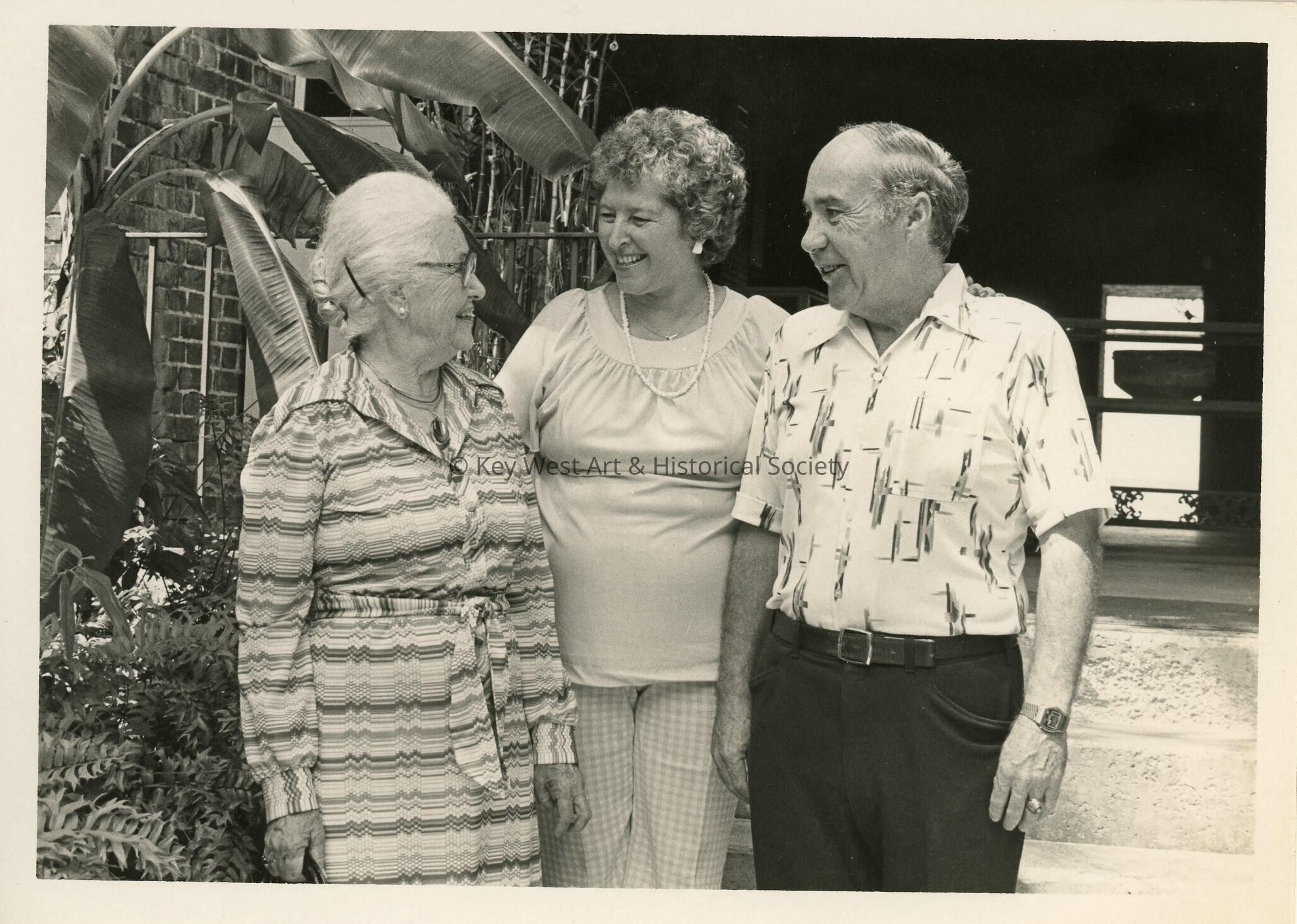 3 Unknown people standing talking