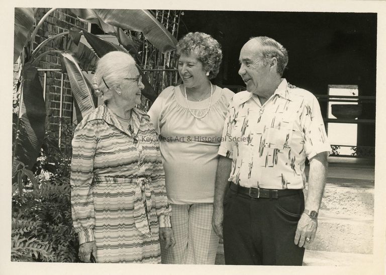 3 Unknown people standing talking
