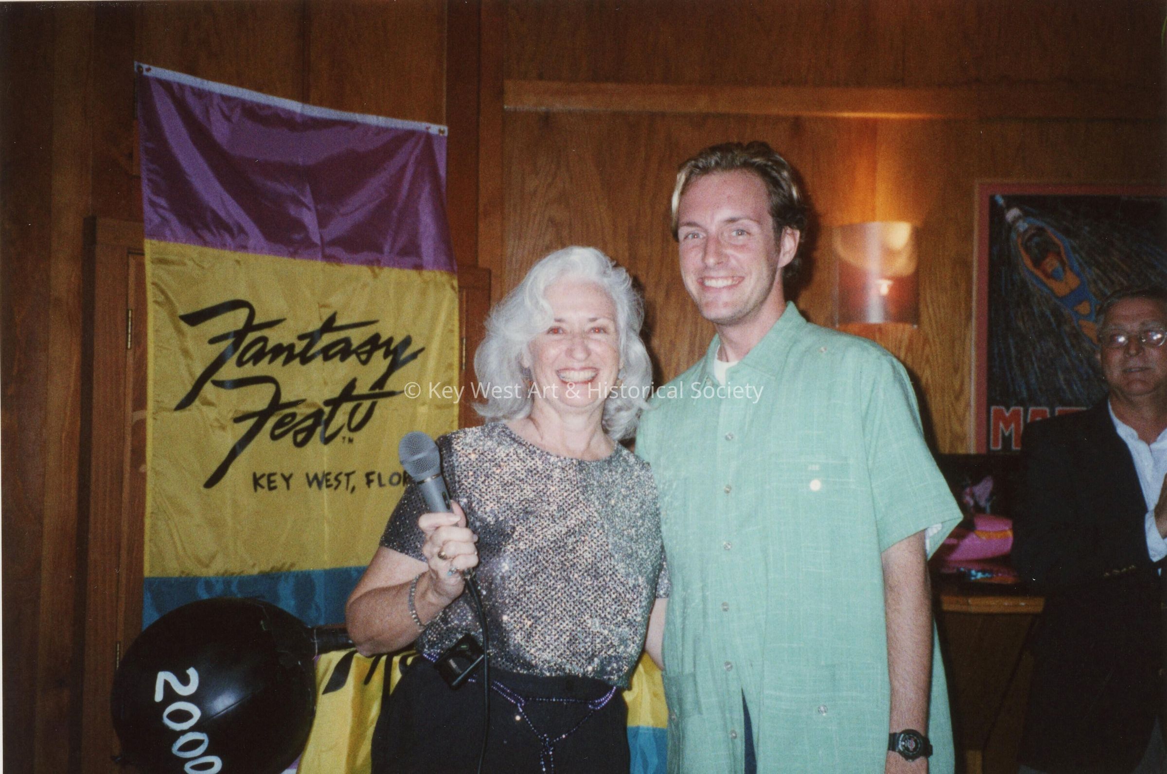 An unknown woman and man at an award ceremony.