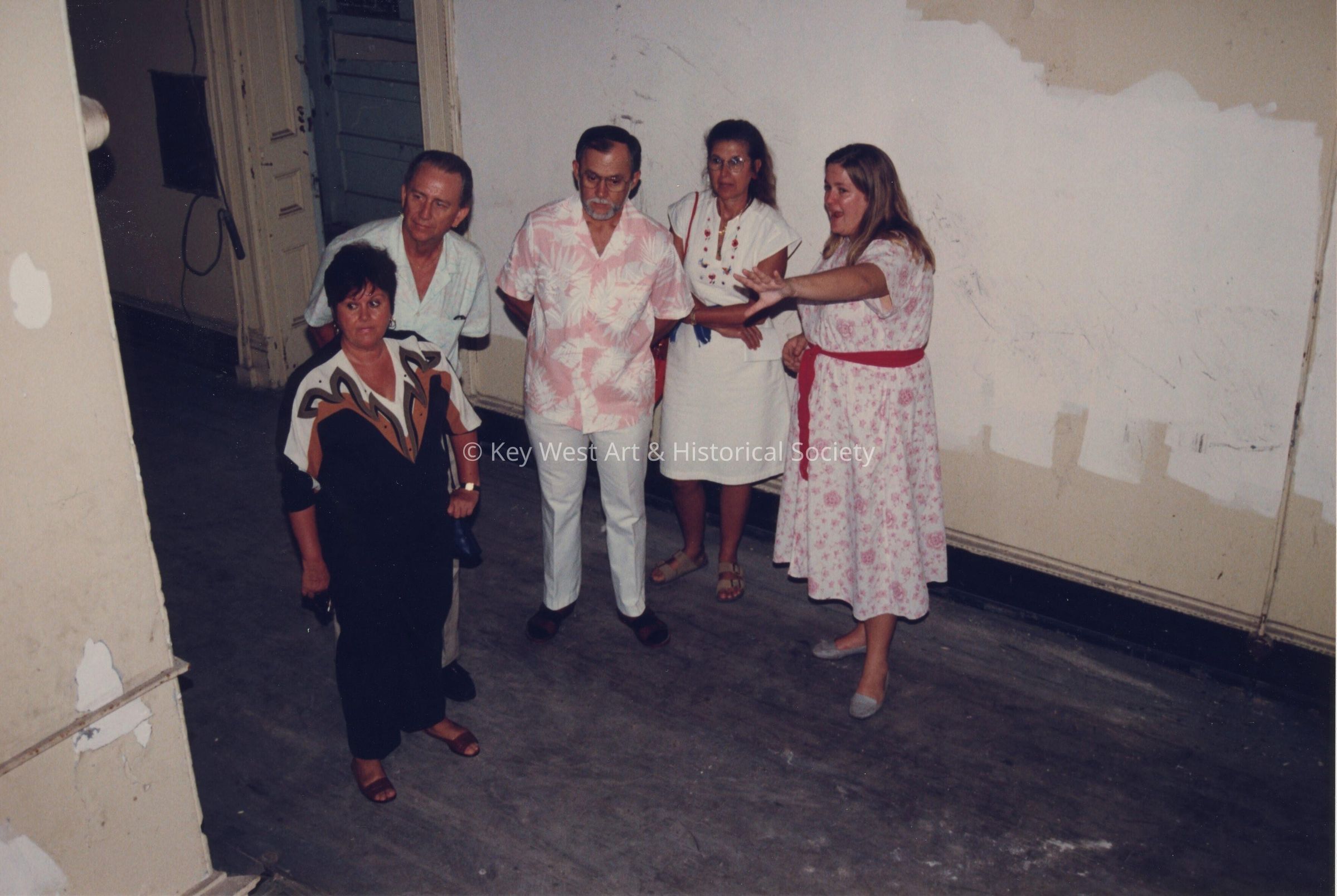 A group of unknown people standing inside.