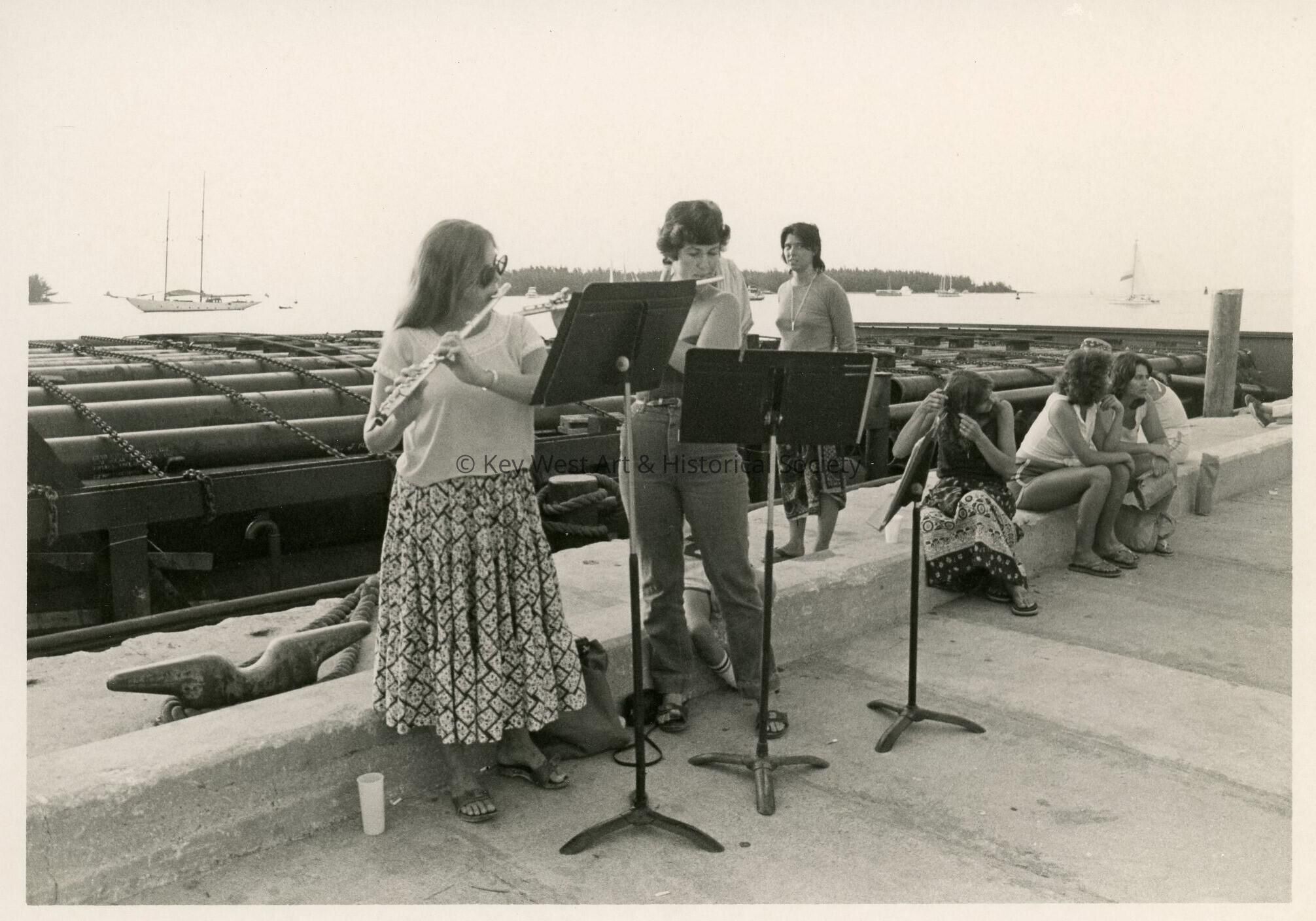 A group of unknown people playing flutes