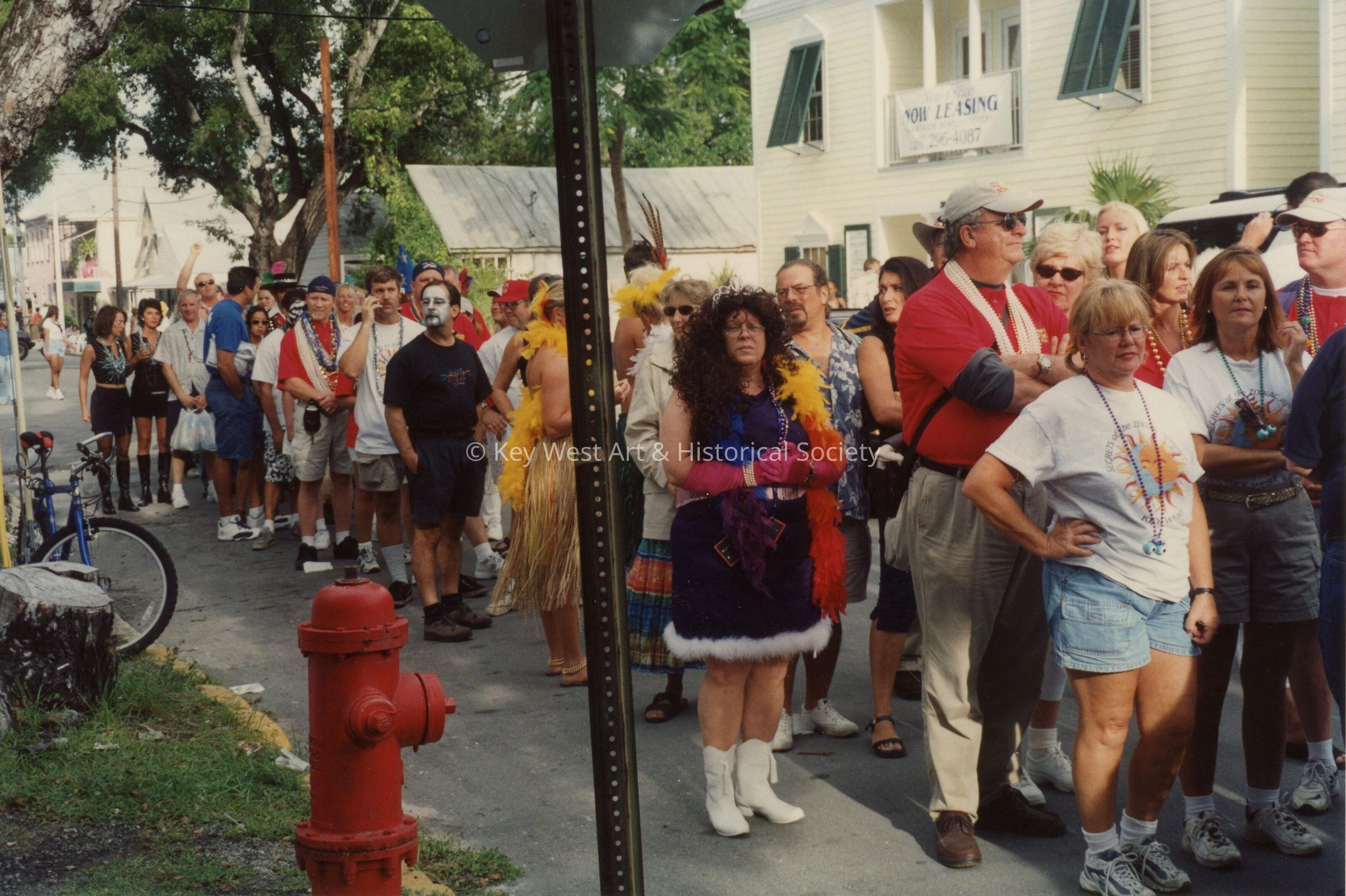 A group of unknown people waiting in a line.