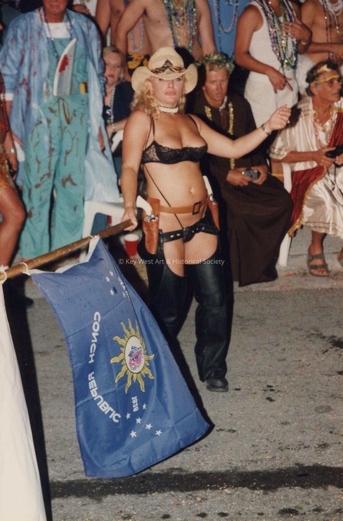 An unknown woman dressed up holding a Conch Republic.