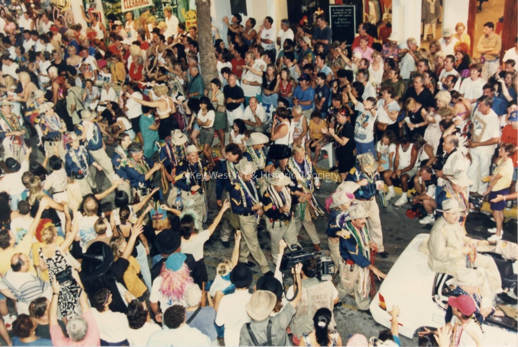 A group of people in the street during the parade.