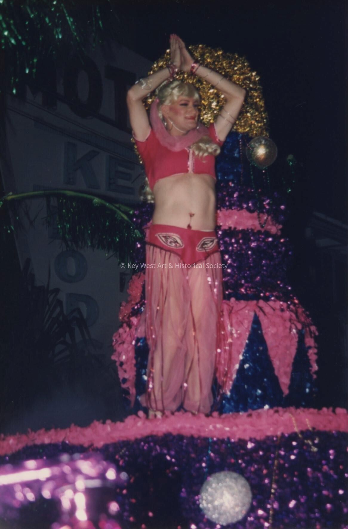 An unknown woman dressed up on a float in the parade.