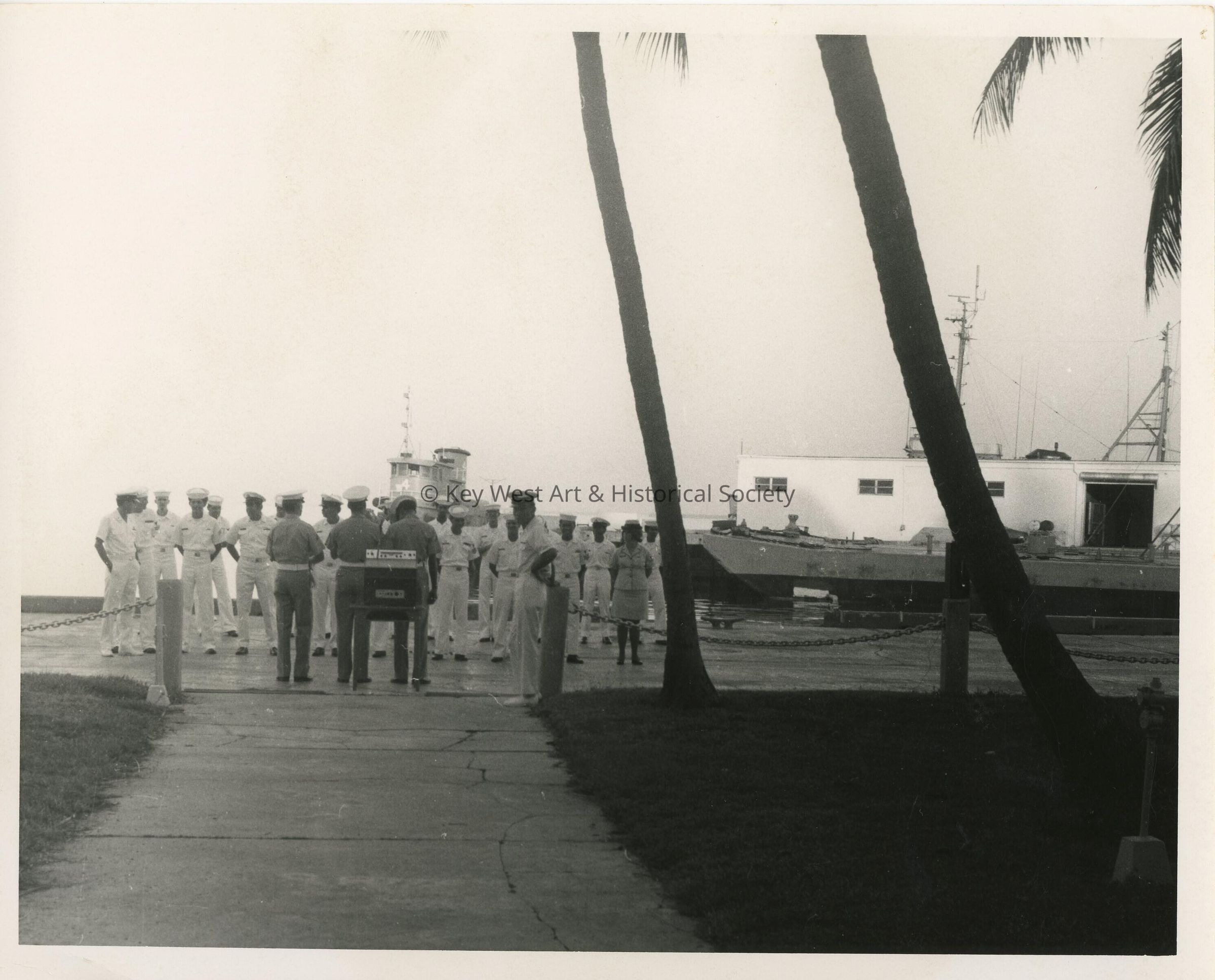 A group of people in uniform near the pier