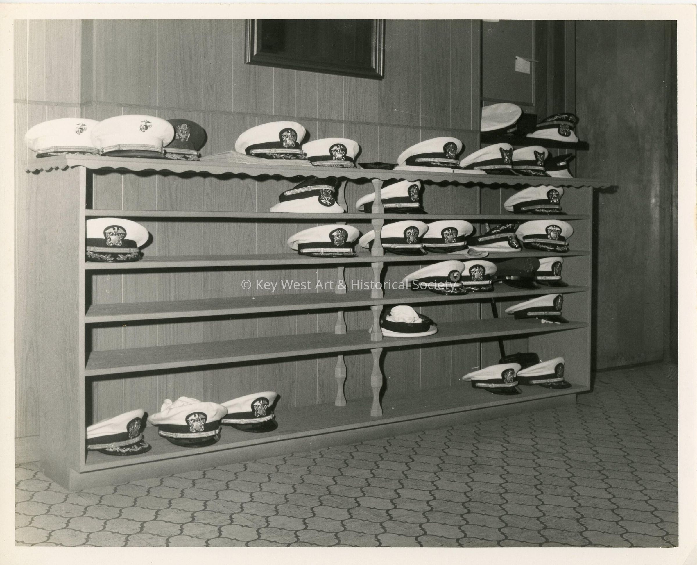 A shelf with military hats