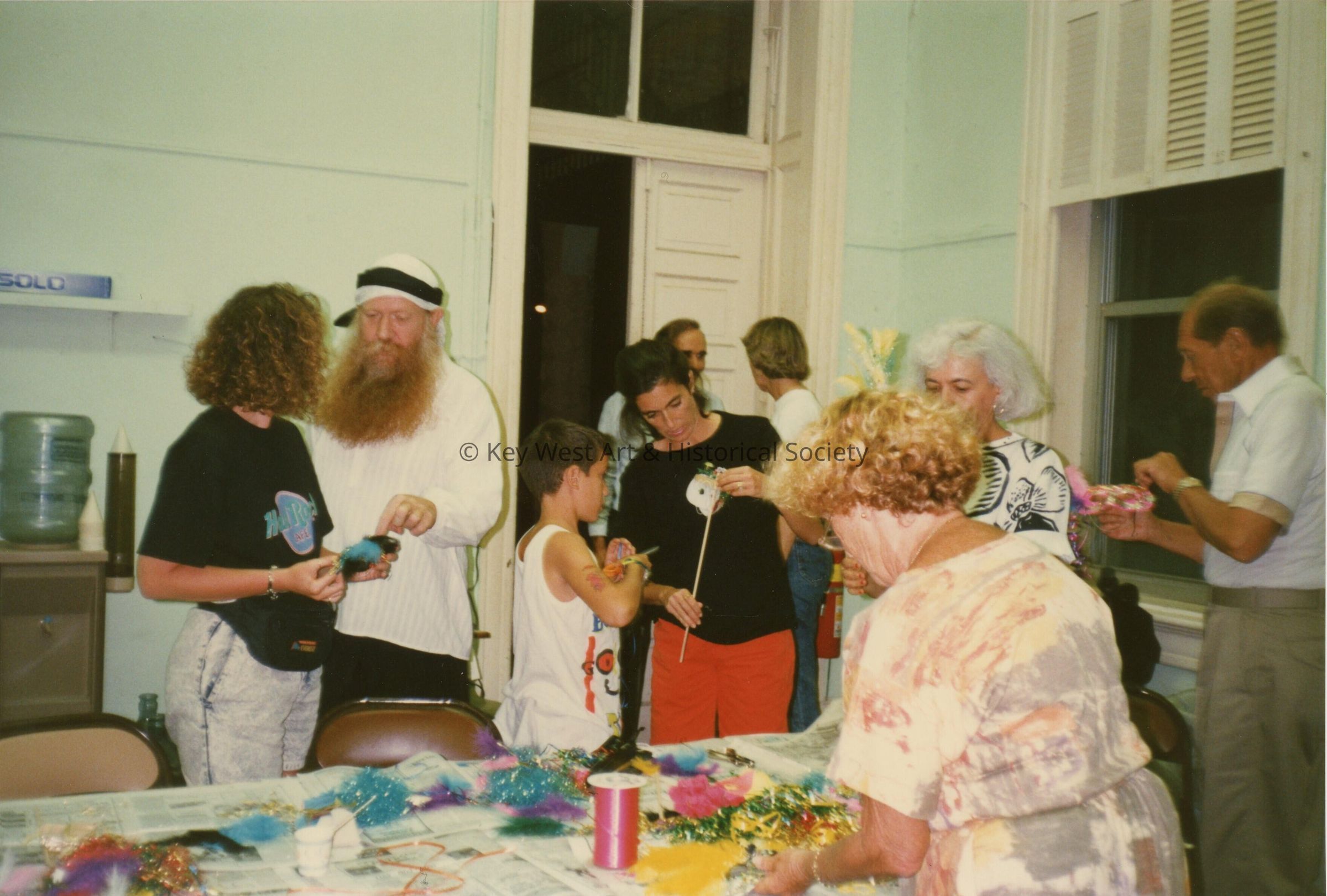 A group of unknown people working on face mask.