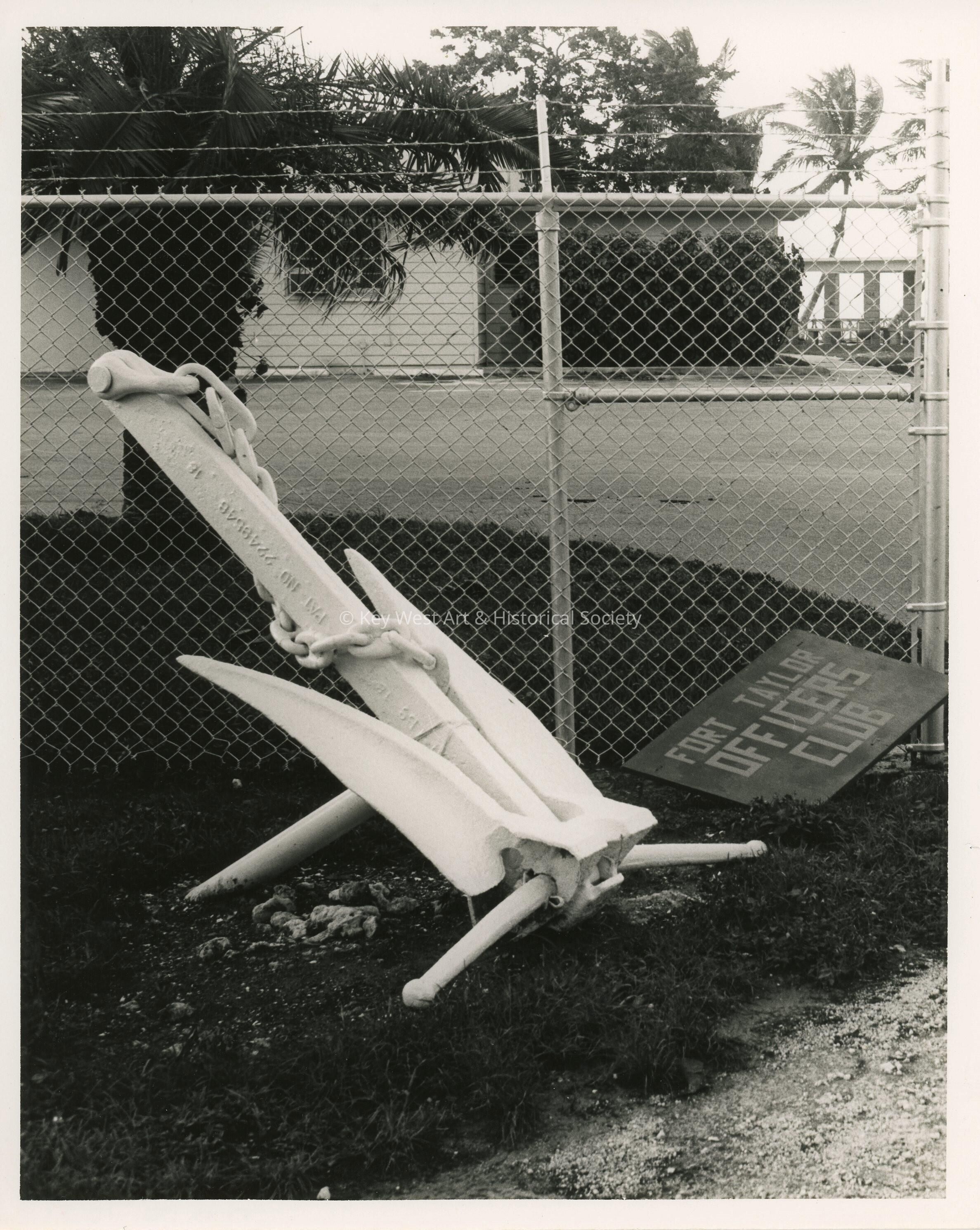 An Anchor sitting next to a sign that reads Fort Taylor Officers club