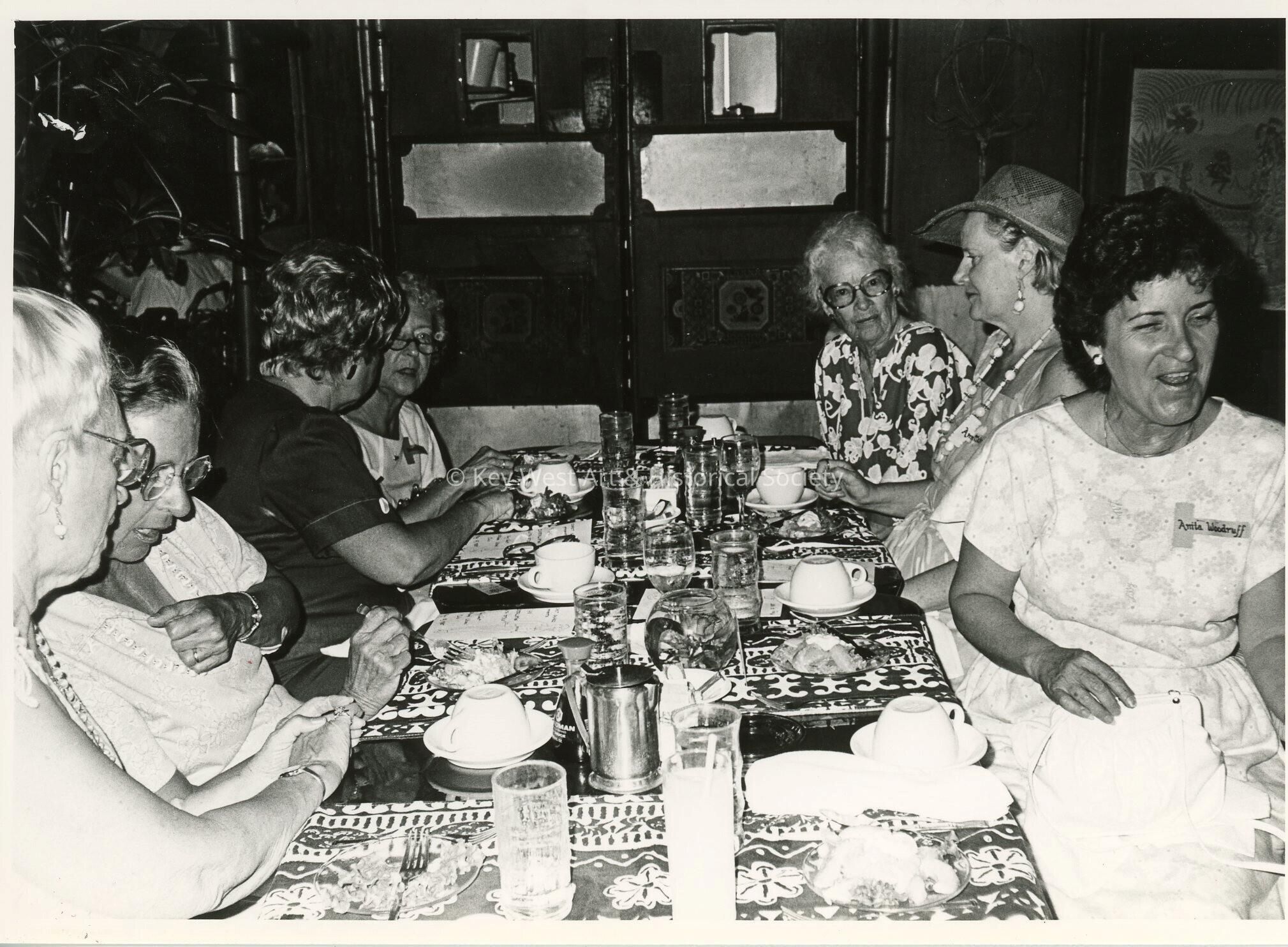 A group of unknown woman sitting at a table