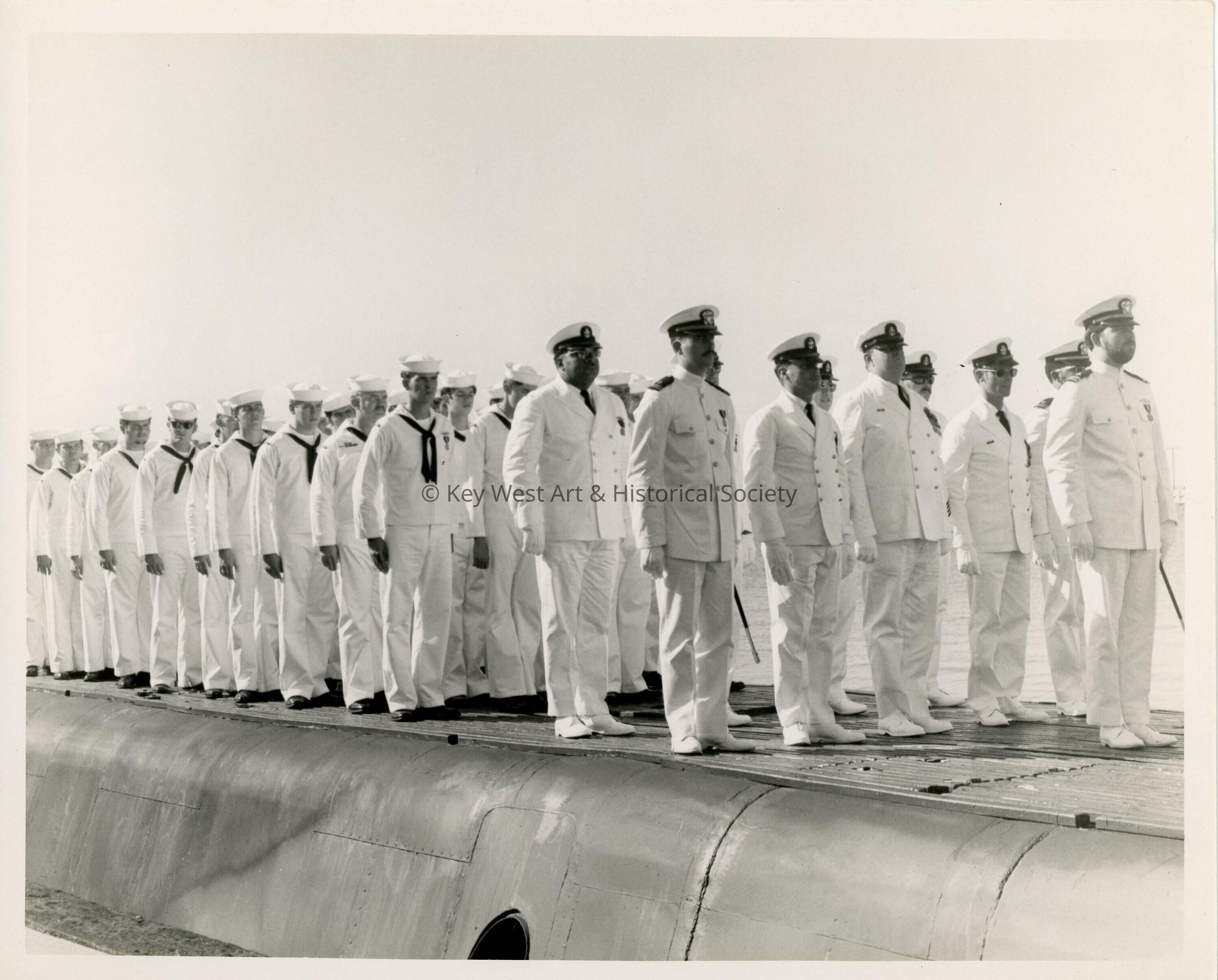 A group of men in uniform standing on a ship