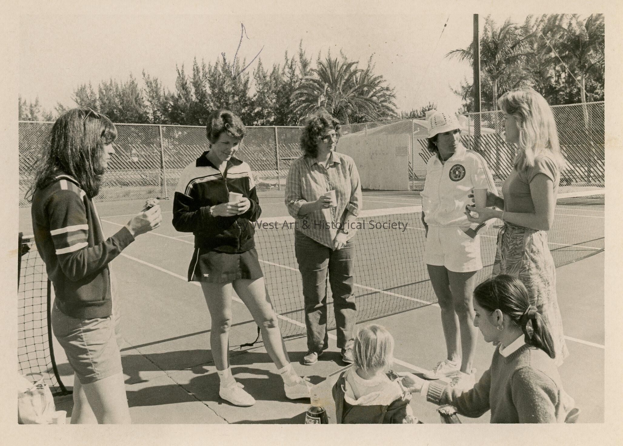 A group of people at the tennis courts