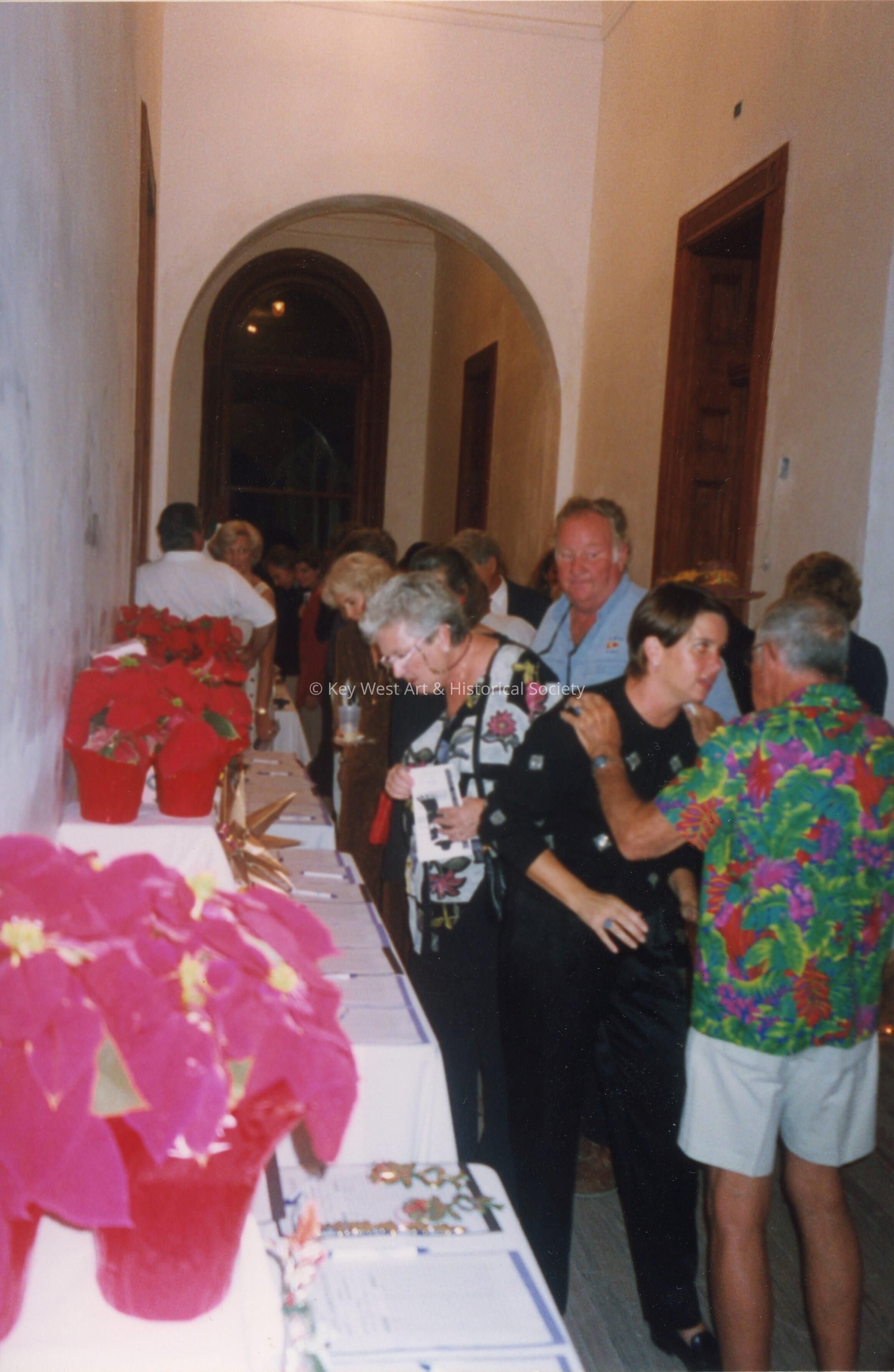 A group of unknown people standing inside.