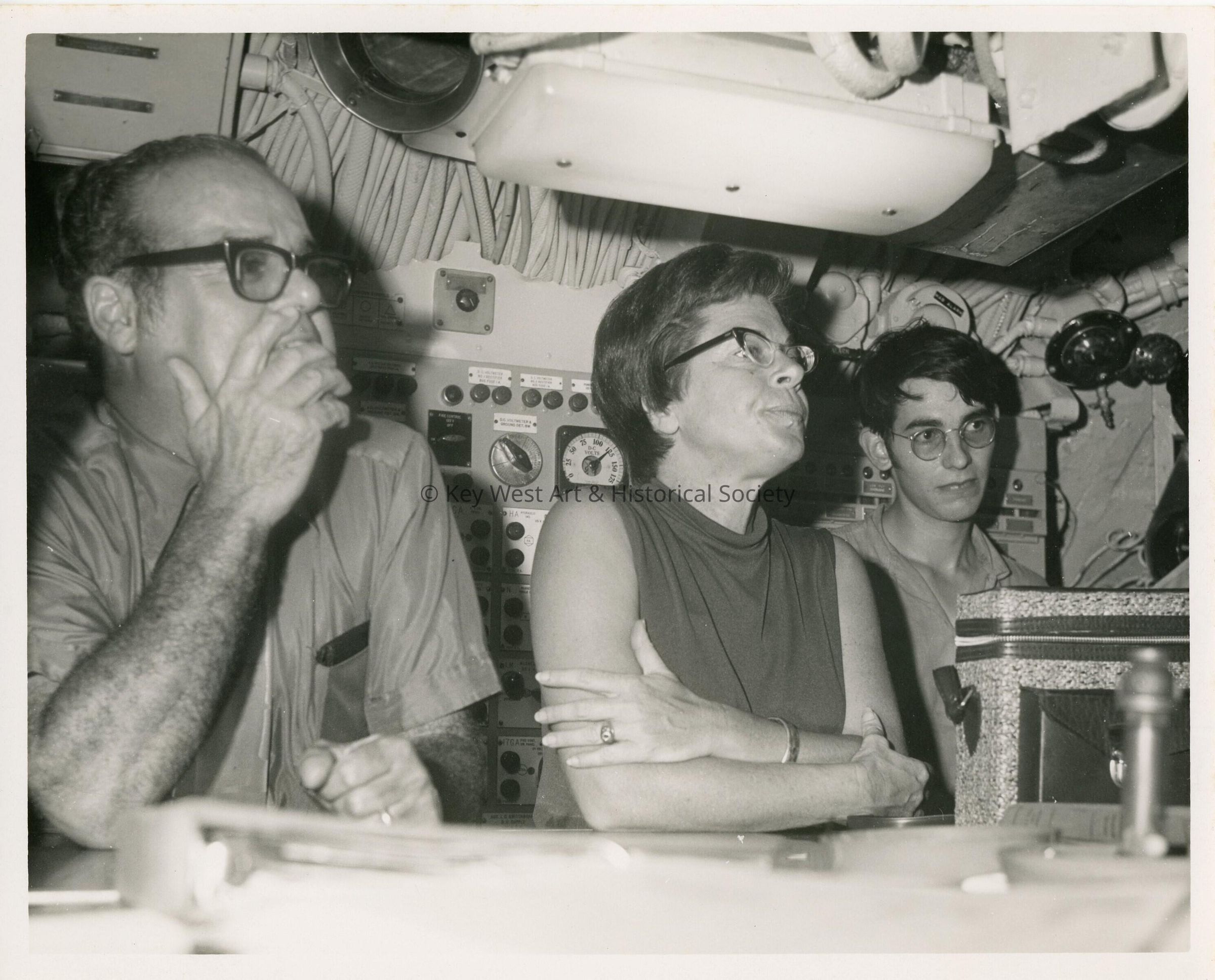 3 Unknown people looking at something in front of them