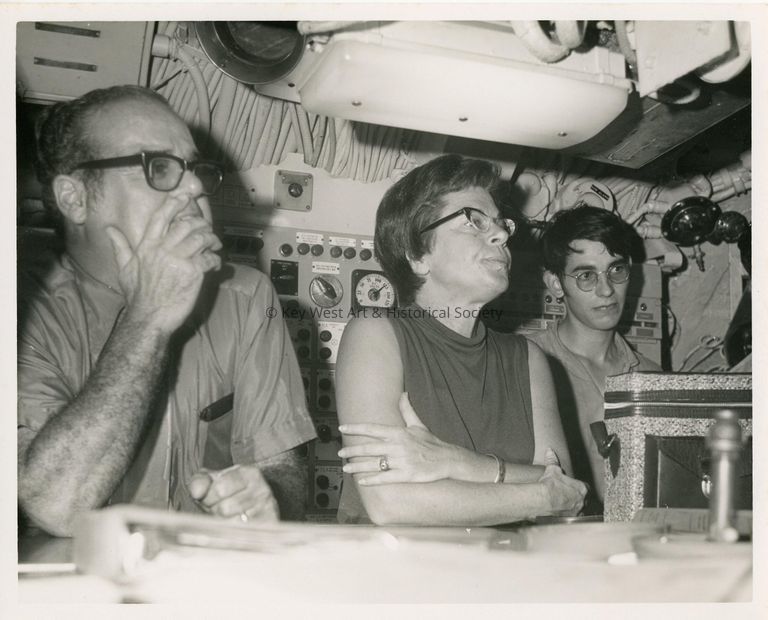 3 Unknown people looking at something in front of them