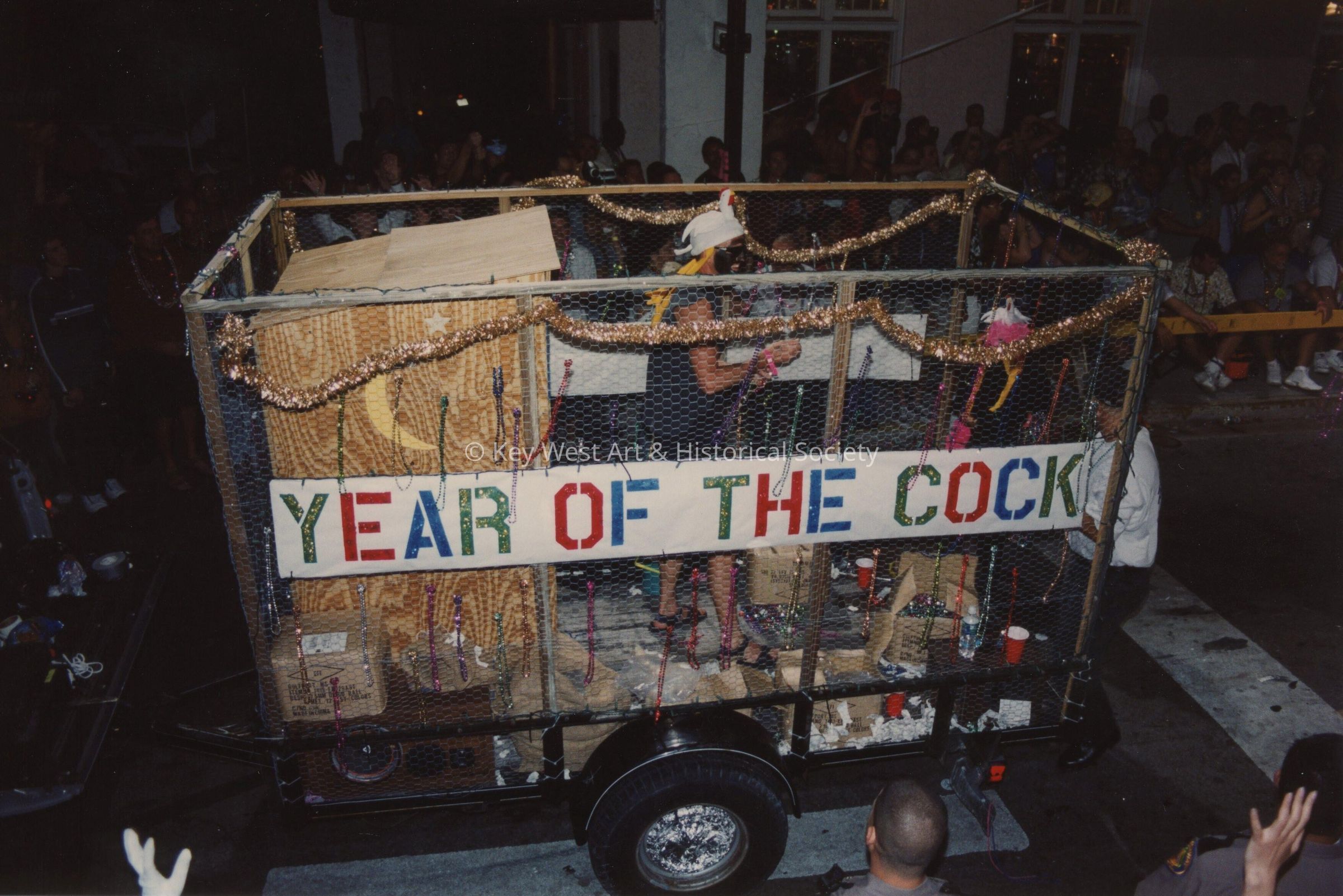 A float in the parade that reads year of the cock.
