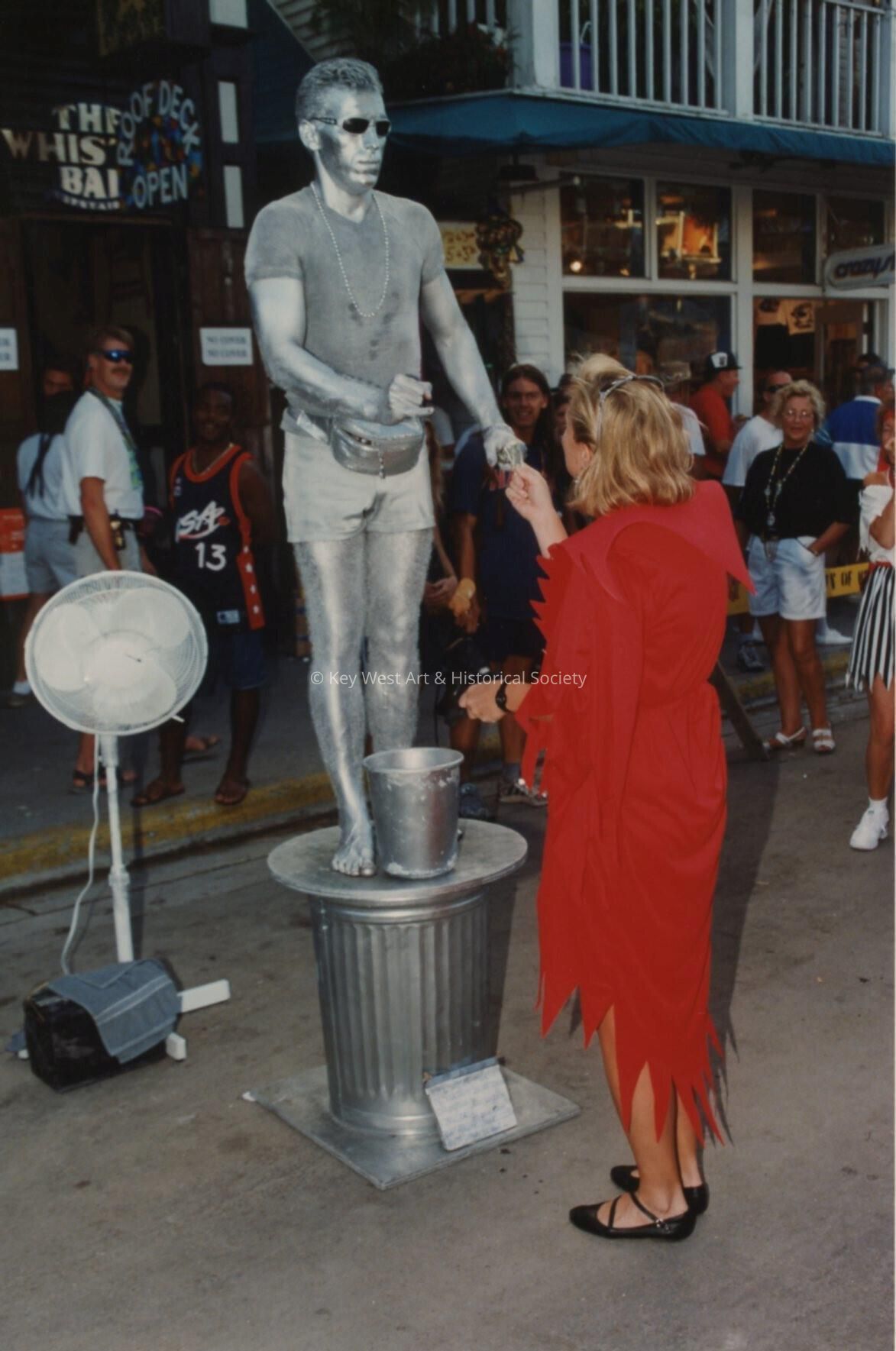 An unknown woman holding the Silver man's hand.
