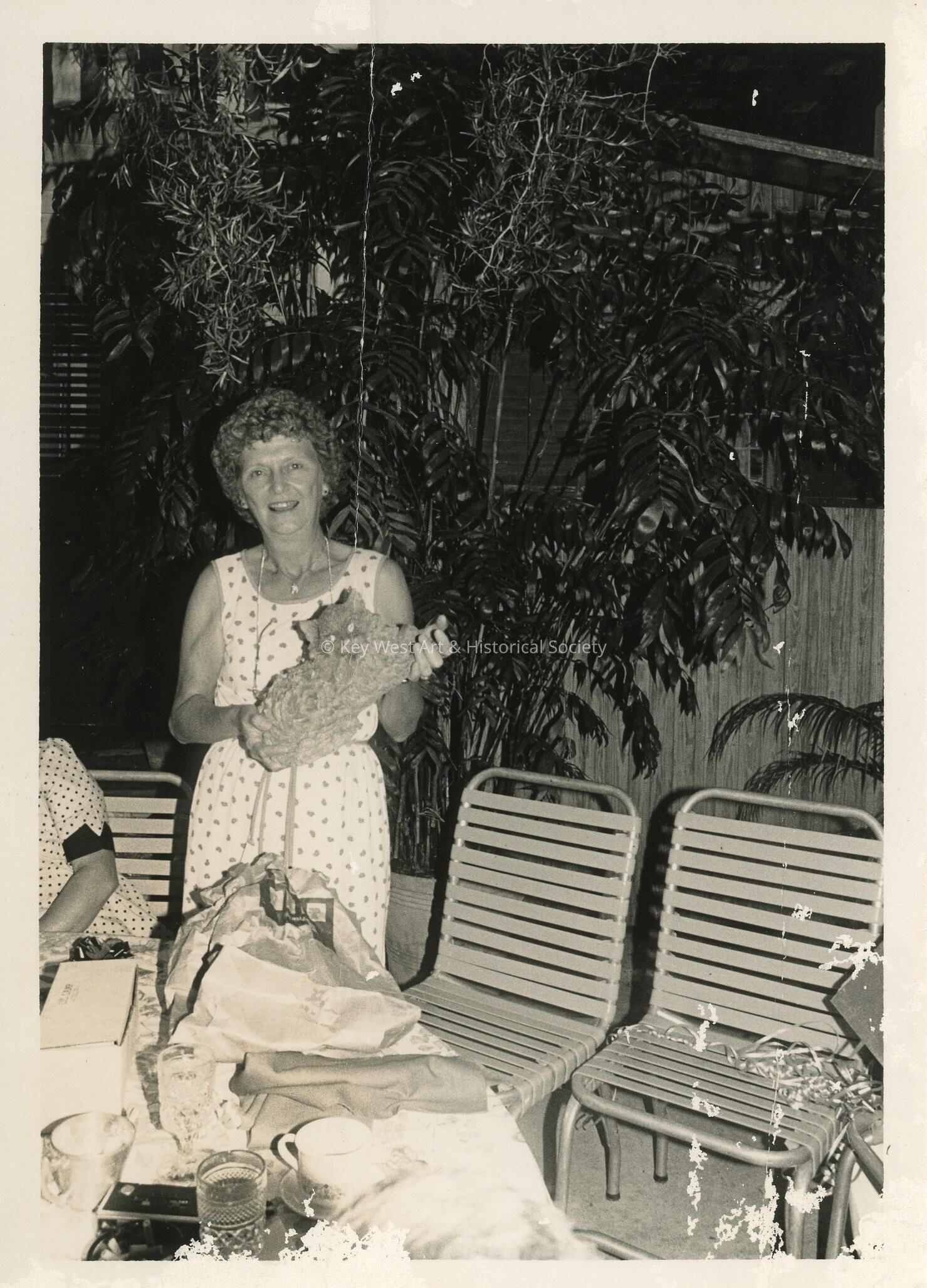 A lady holding a cat sculpture