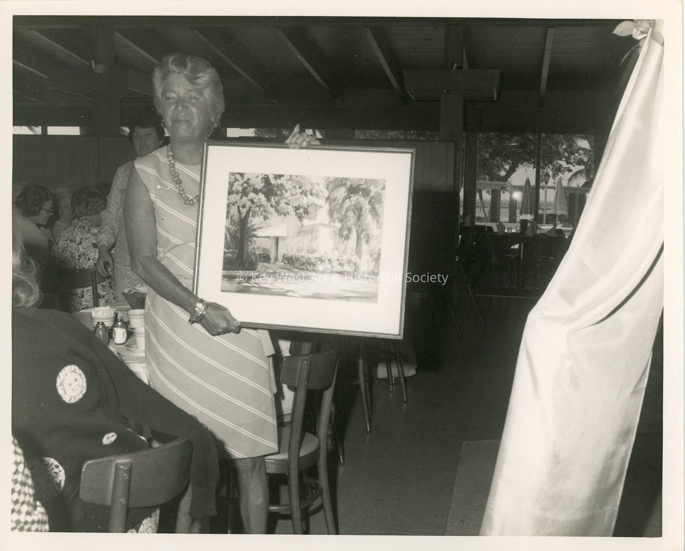 An unknown woman showing of an art piece