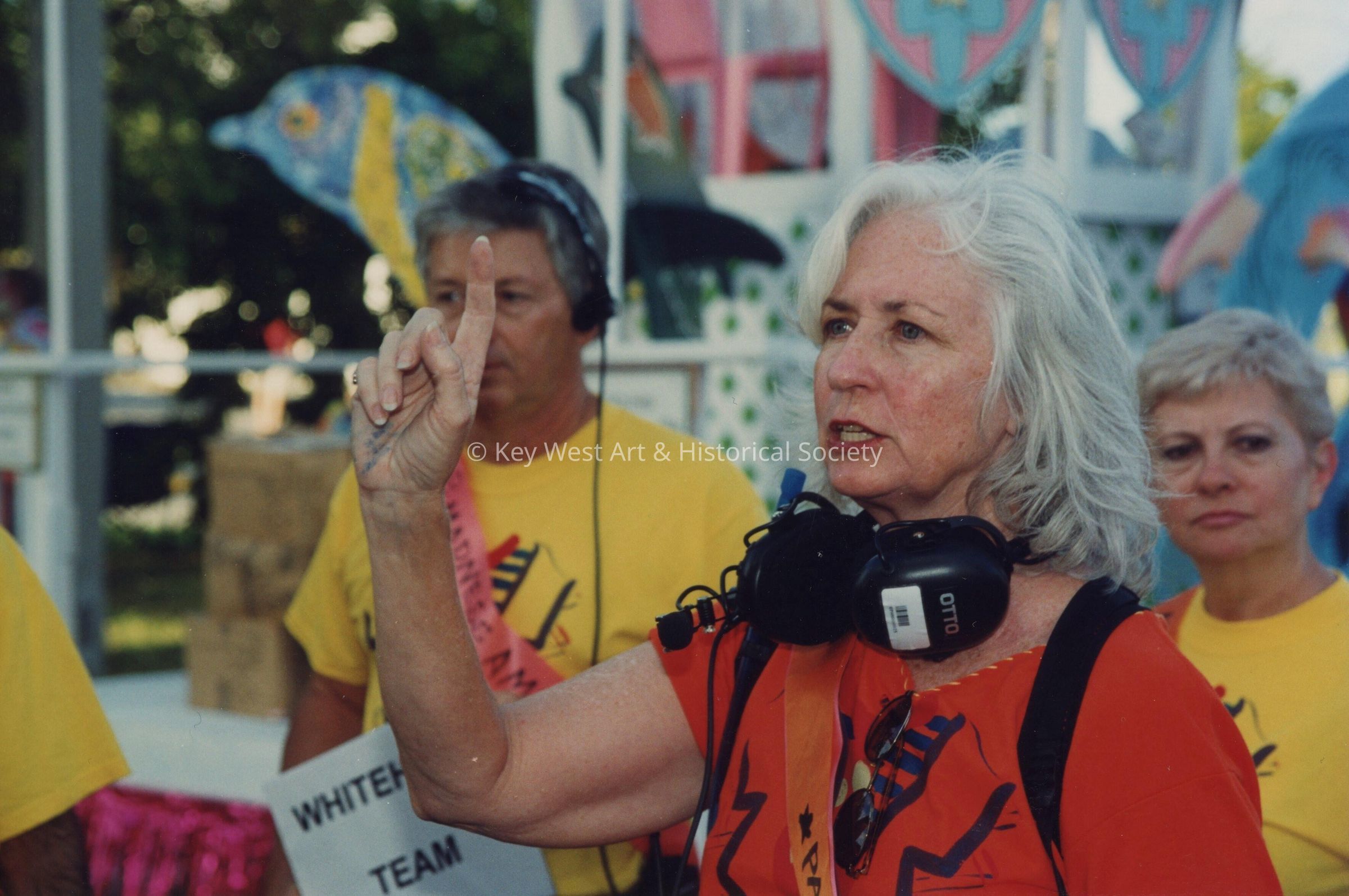 An unknown woman who is one of the parade monitors.