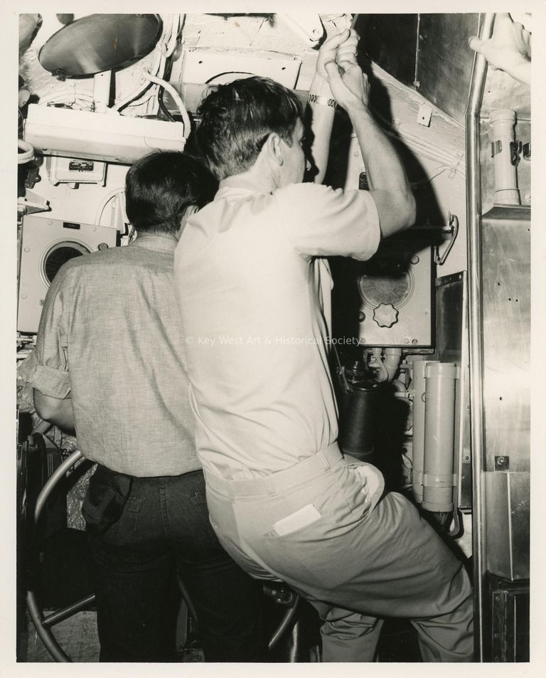 2 Unknown men working on a ship