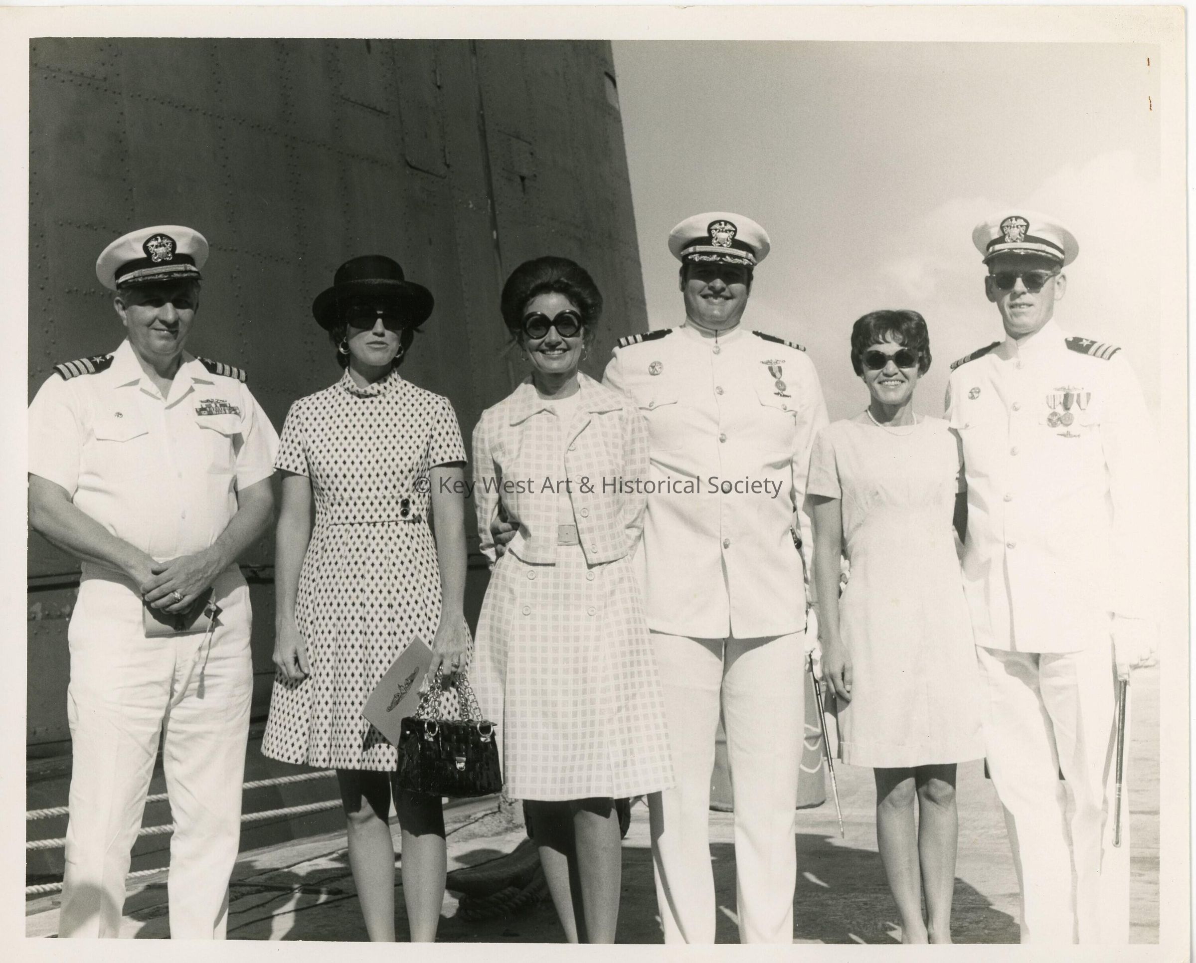 A group of unknown people some in uniform on a ship