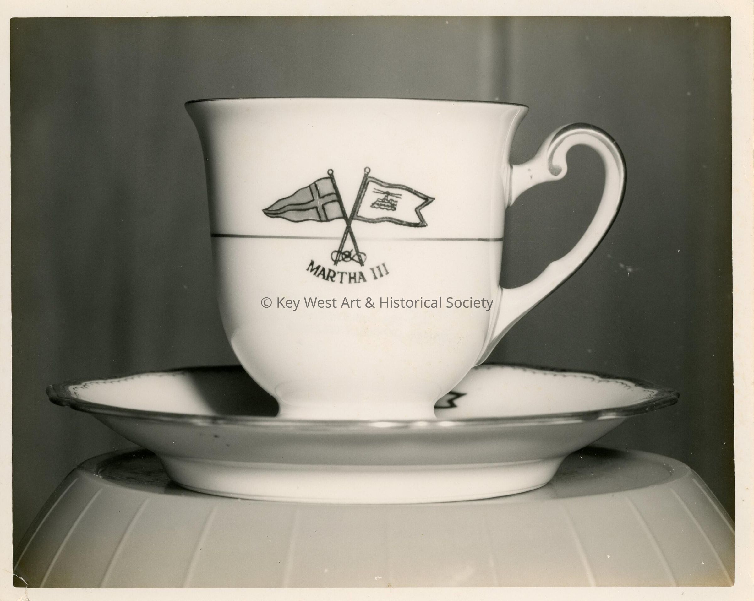 A mug and plate, that reads Martha III