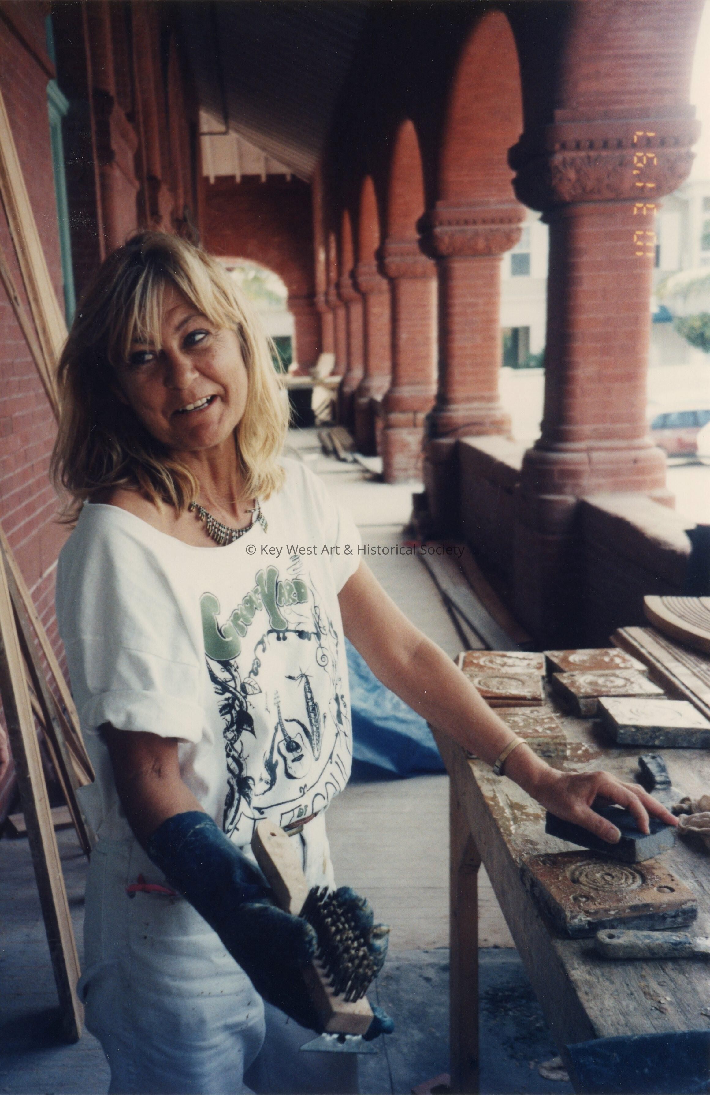 An unknown woman working on terra cotta on the porch.
