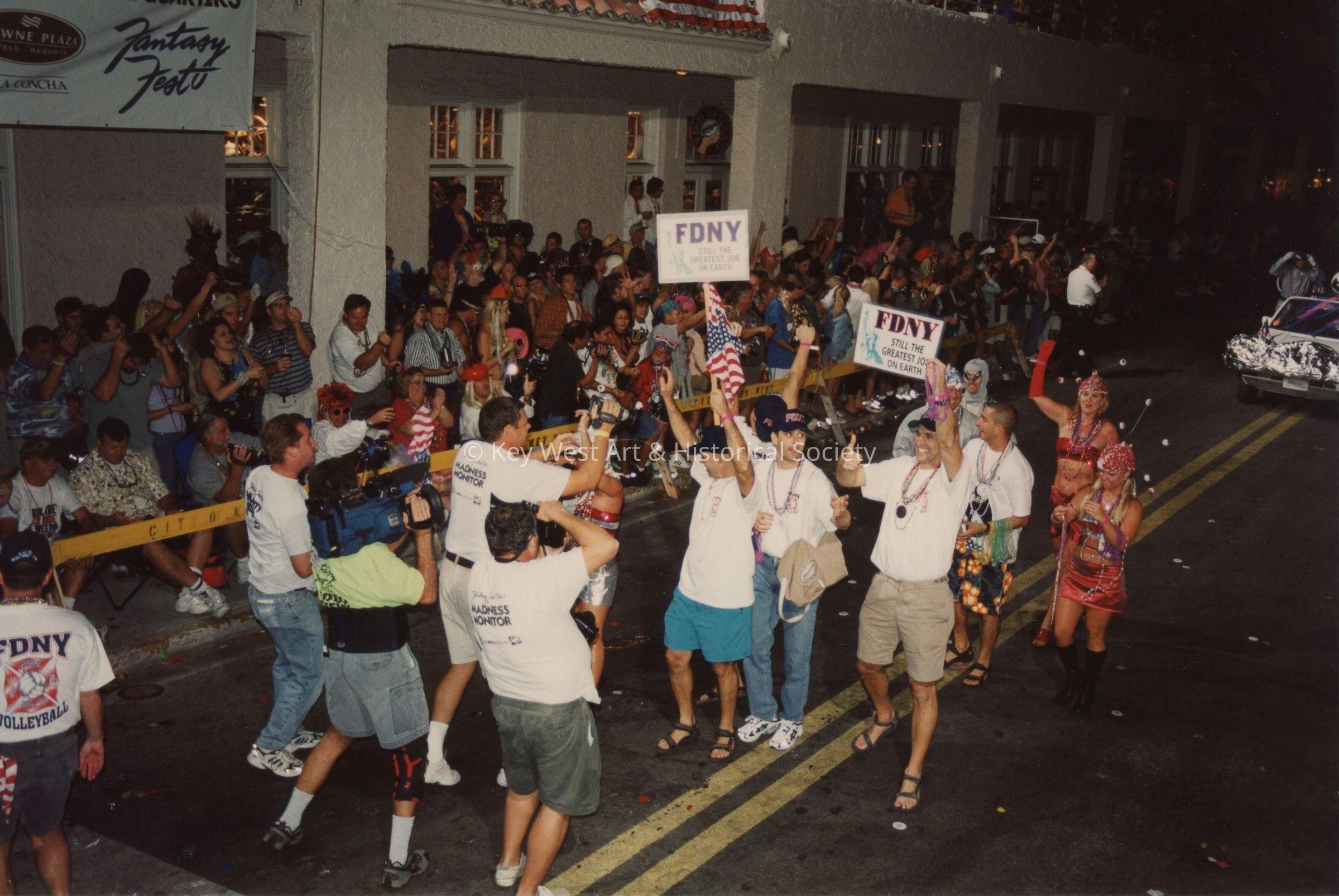 A group of unknown people walking in the street for the parade.