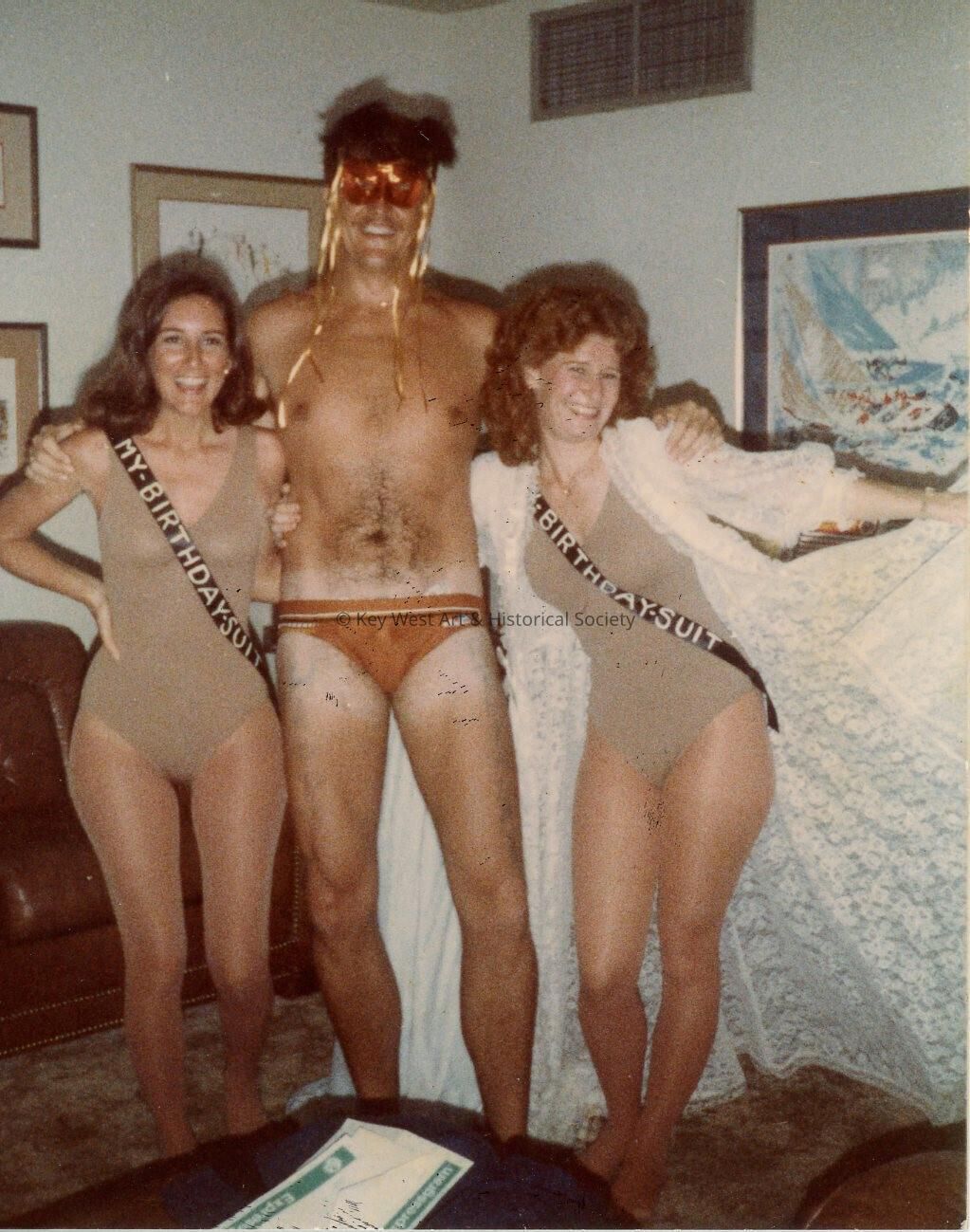 3 Unknown people dressed up for a party
