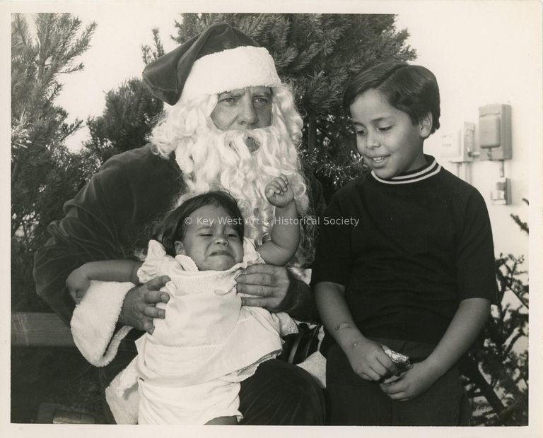 2 Unknown boys sitting with Santa Clause