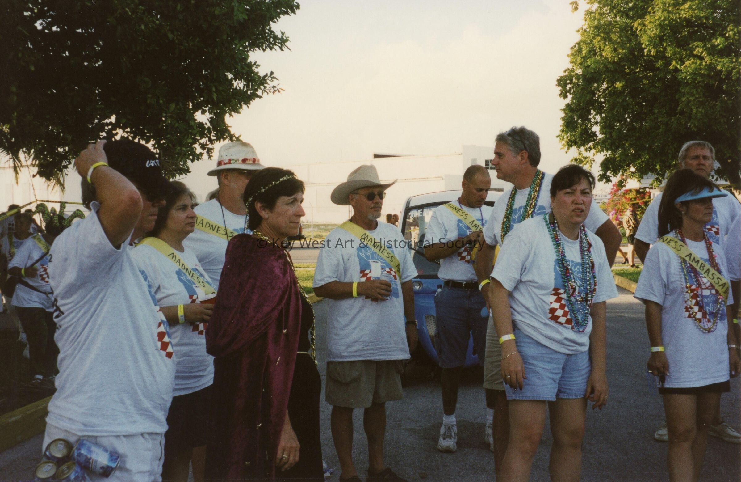 A group of unknown people standing around.