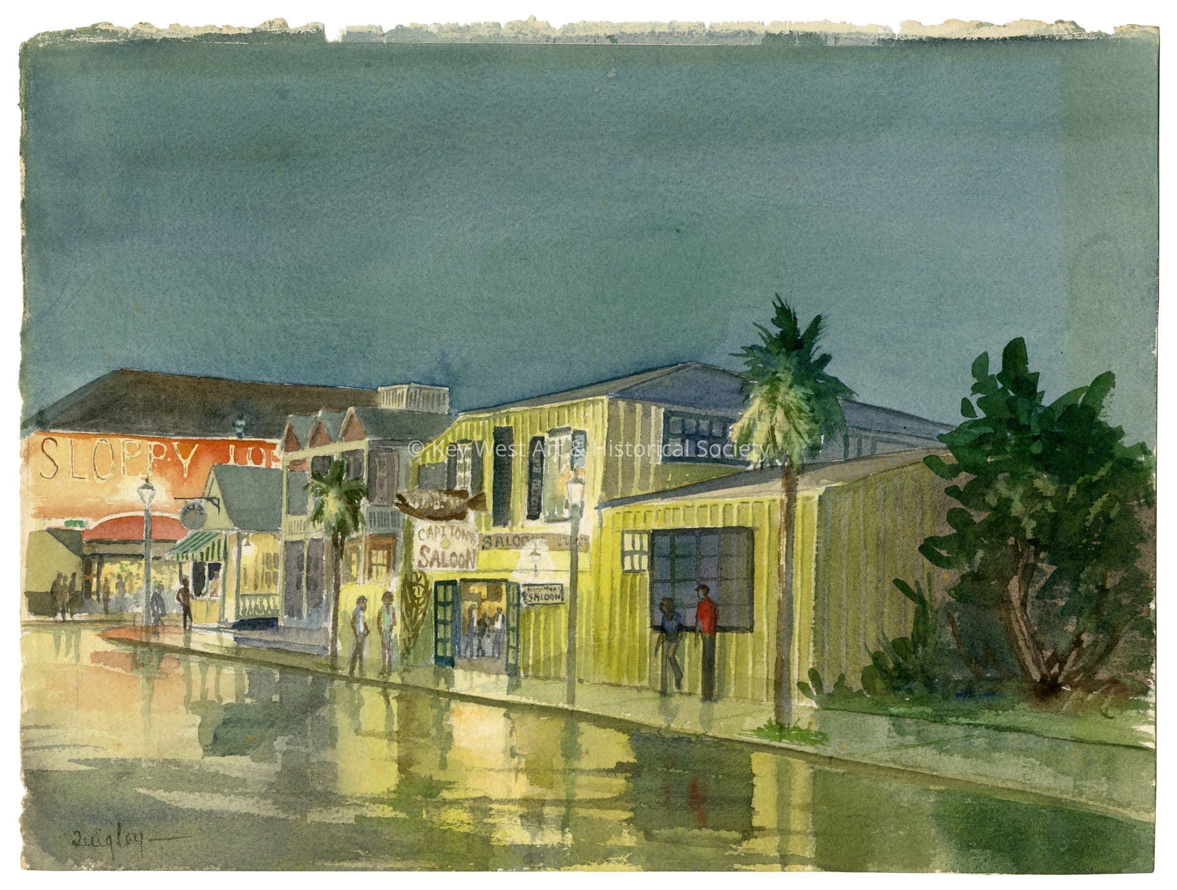 © Key West Art & Historical Society: The image is a watercolor painting depicting a charming street scene at twilight, possibly after rainfall as indicated by the reflections on the wet pavement. In the foreground is a row of colorful, quaint buildings including one prominently featuring a sign that reads "Sloppy Joe's." Another building is labeled "Capt. Tony’s Saloon." There are several figures casually strolling or standing around, contributing to a relaxed, evening atmosphere. The sky is painted in muted tones suggesting either dawn or dusk, contrasting with the warmly lit street and vibrant architectural hues. Vegetation subtly frames the scene, and the distant background shows a hint of a waterfront, enhancing the painting's coastal town feel.