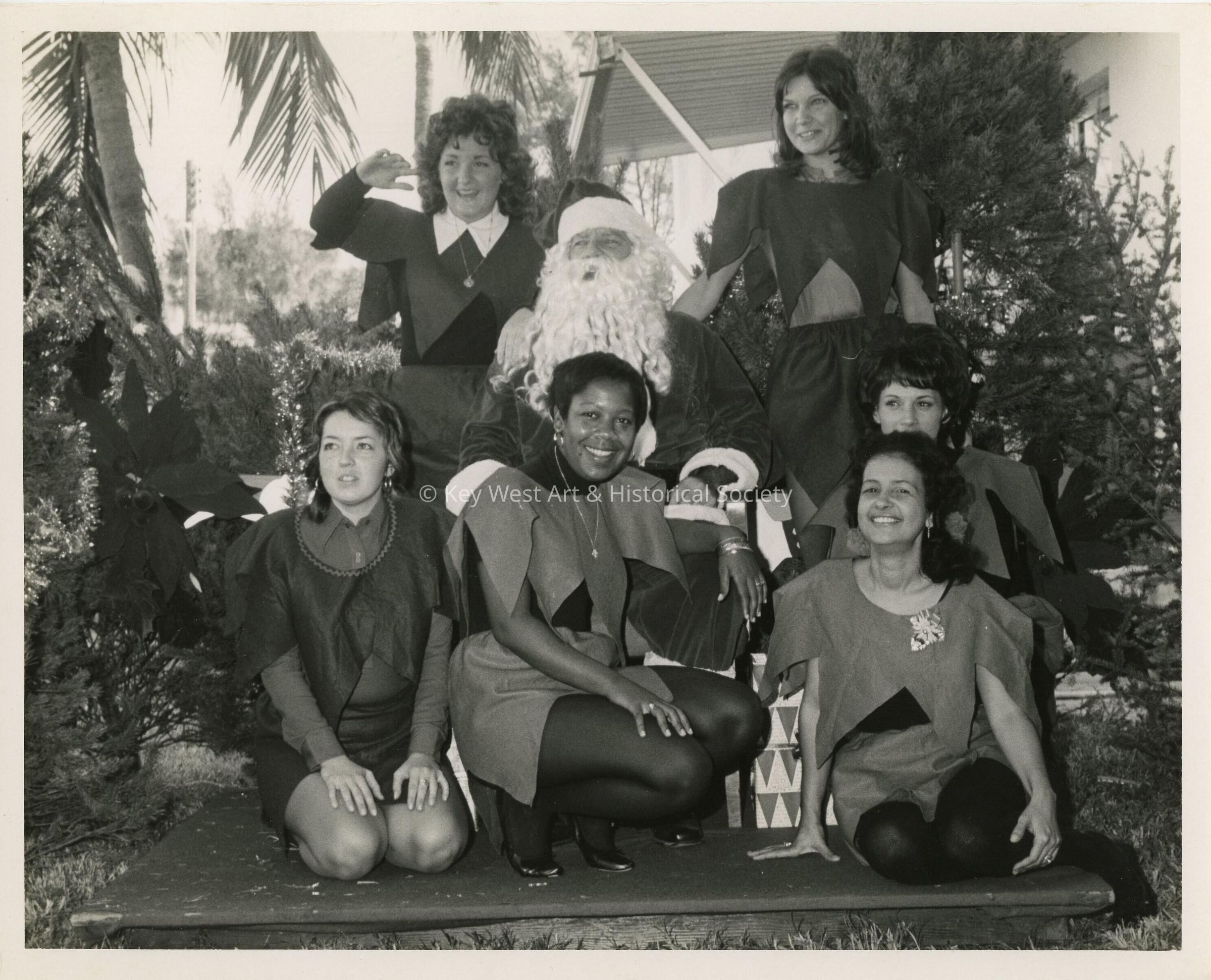 A group of woman sitting with Santa Claus