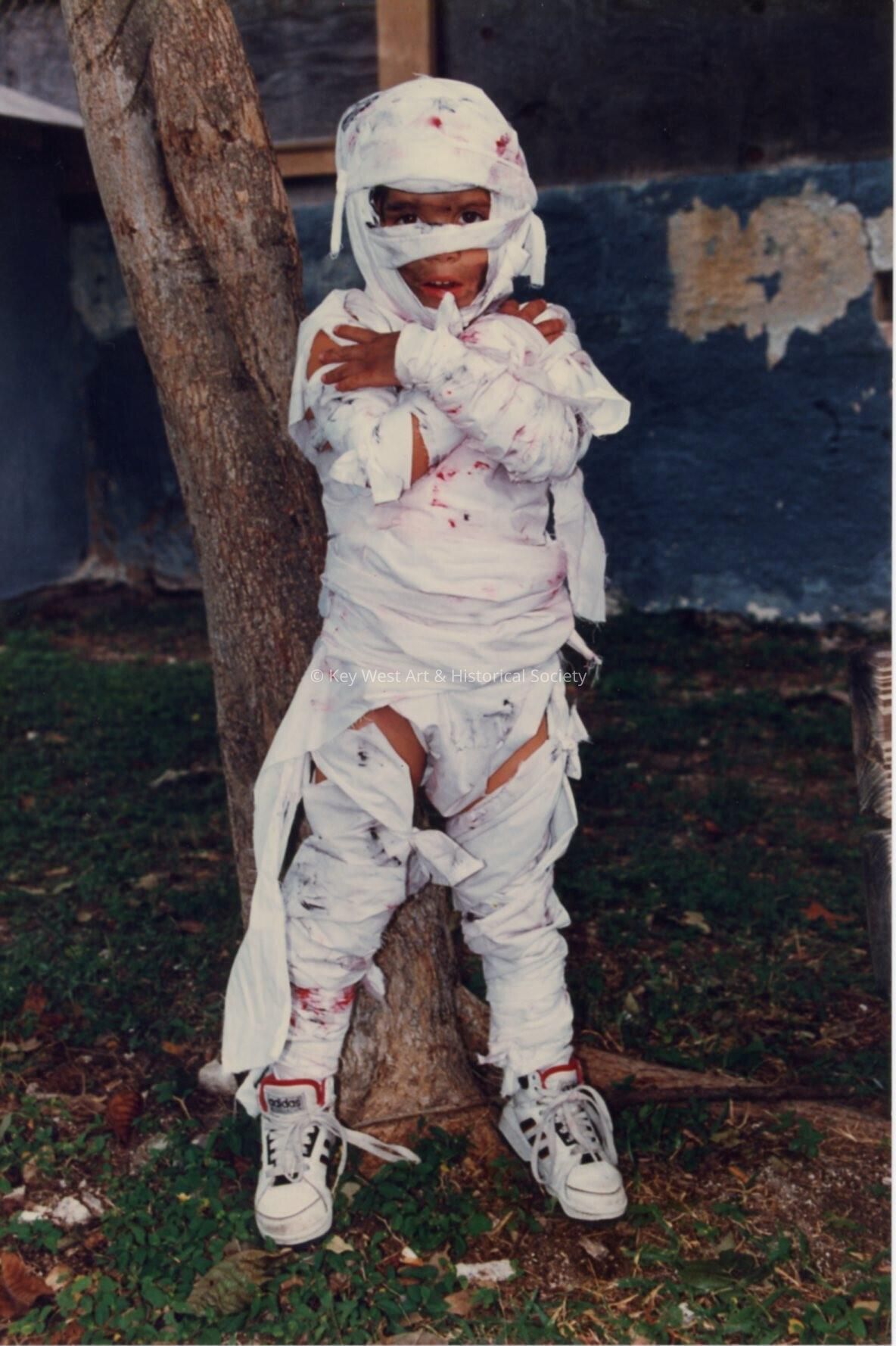 A child dressed up as a mummy for Children's Day.