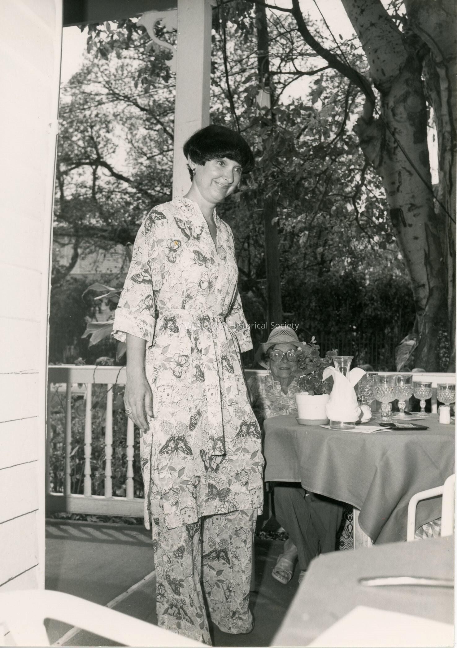 An unknown woman standing