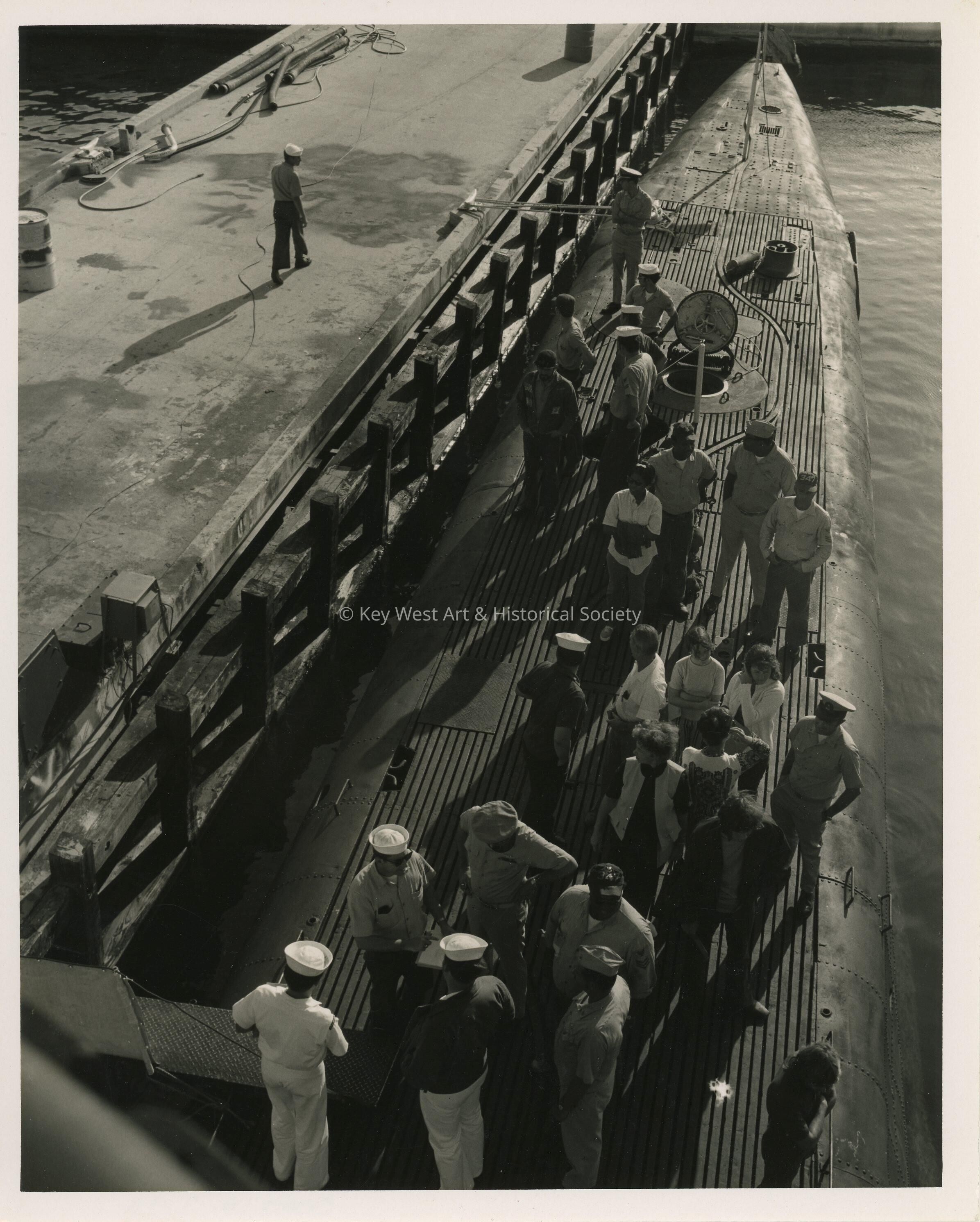 A group of unknown people standing on a ship