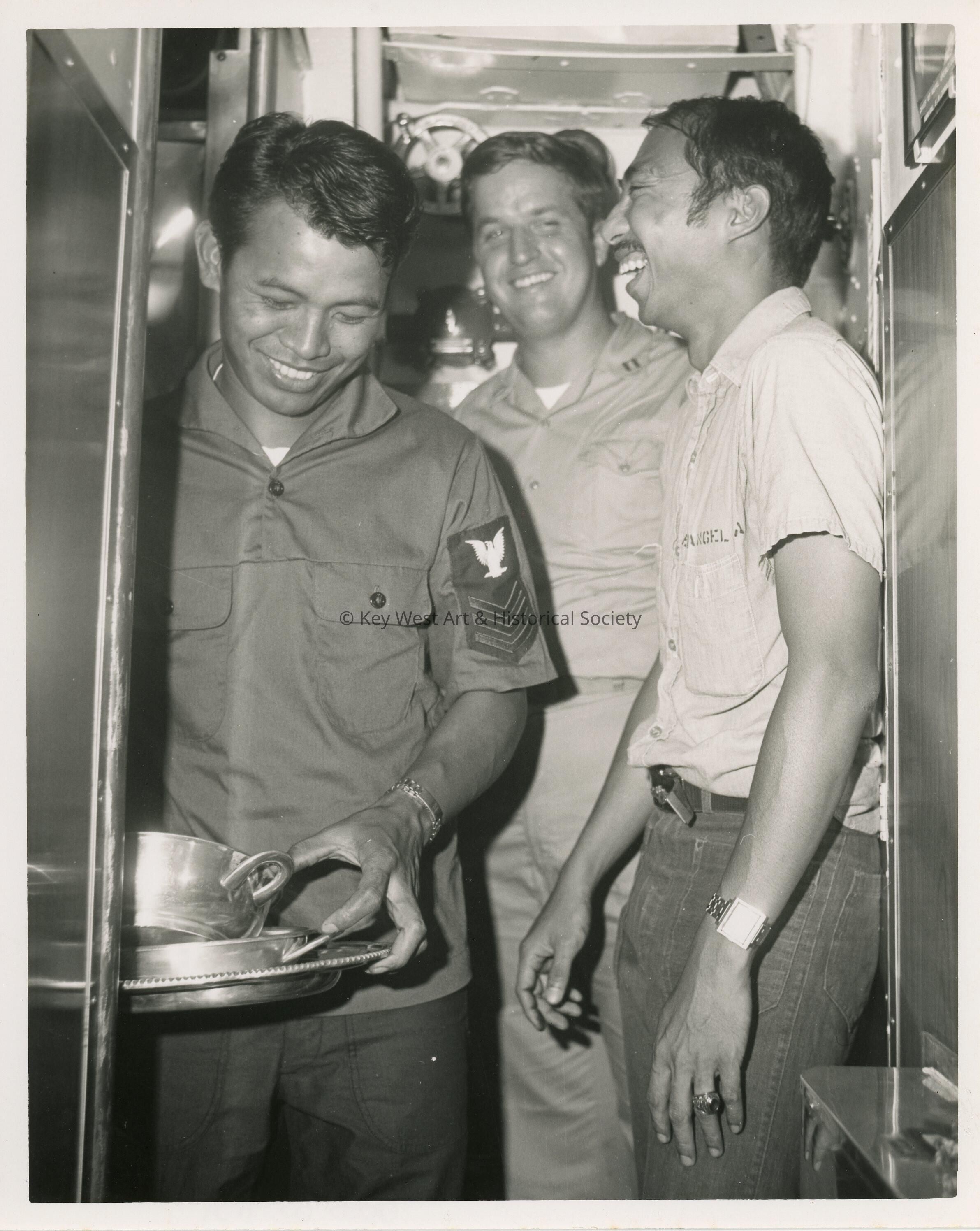 3 Unknown men in uniform in a ship