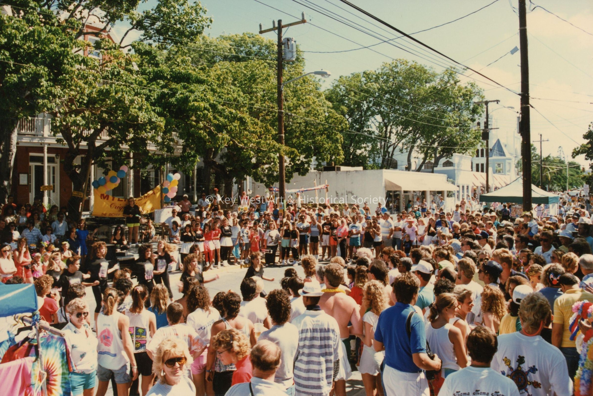 A huge group of unknown people in the street in front of the Woman's club o