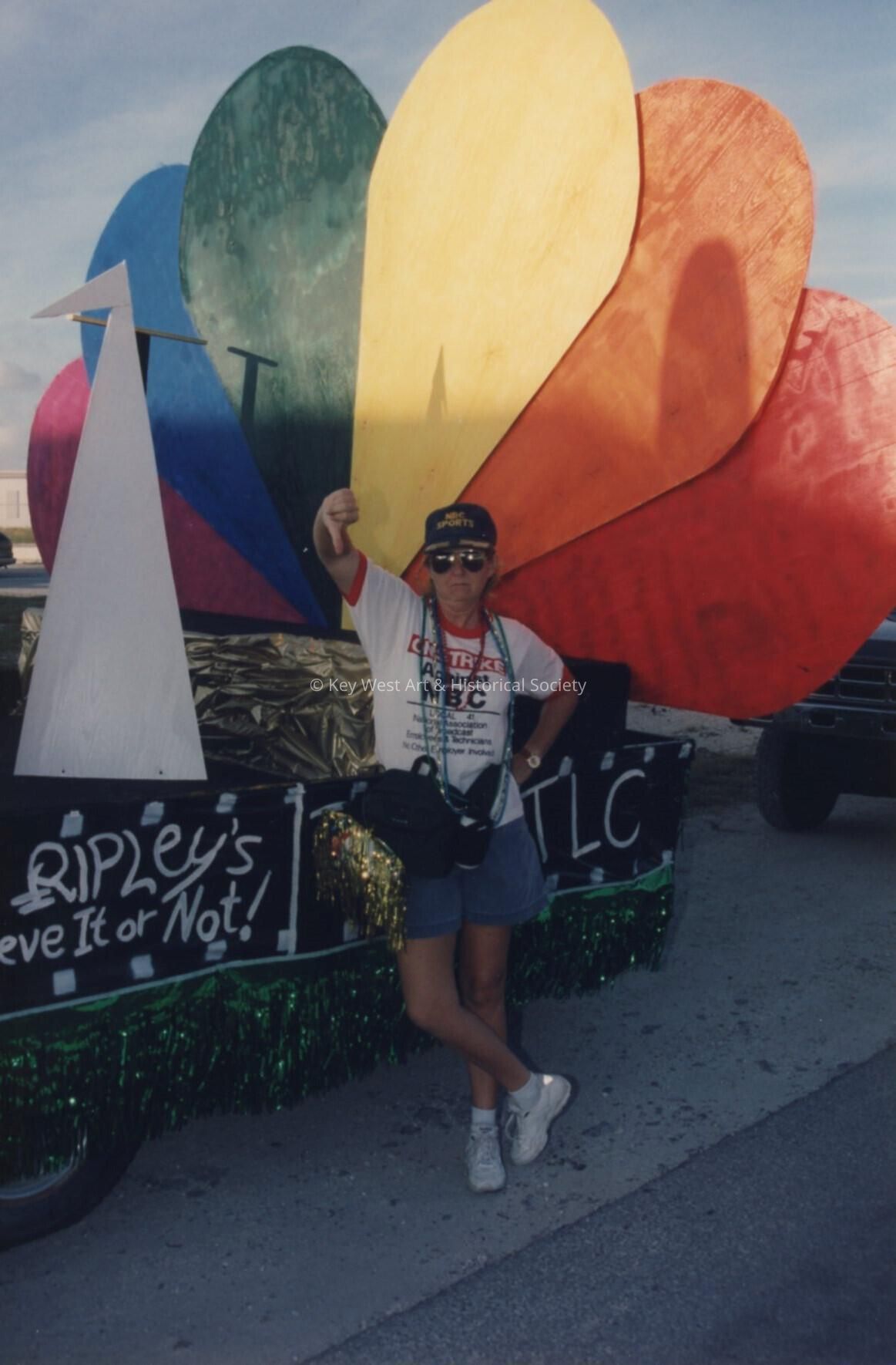 An unknown lady standing in front of a float.