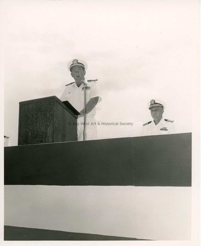 2 Unknown men in uniform at a meeting