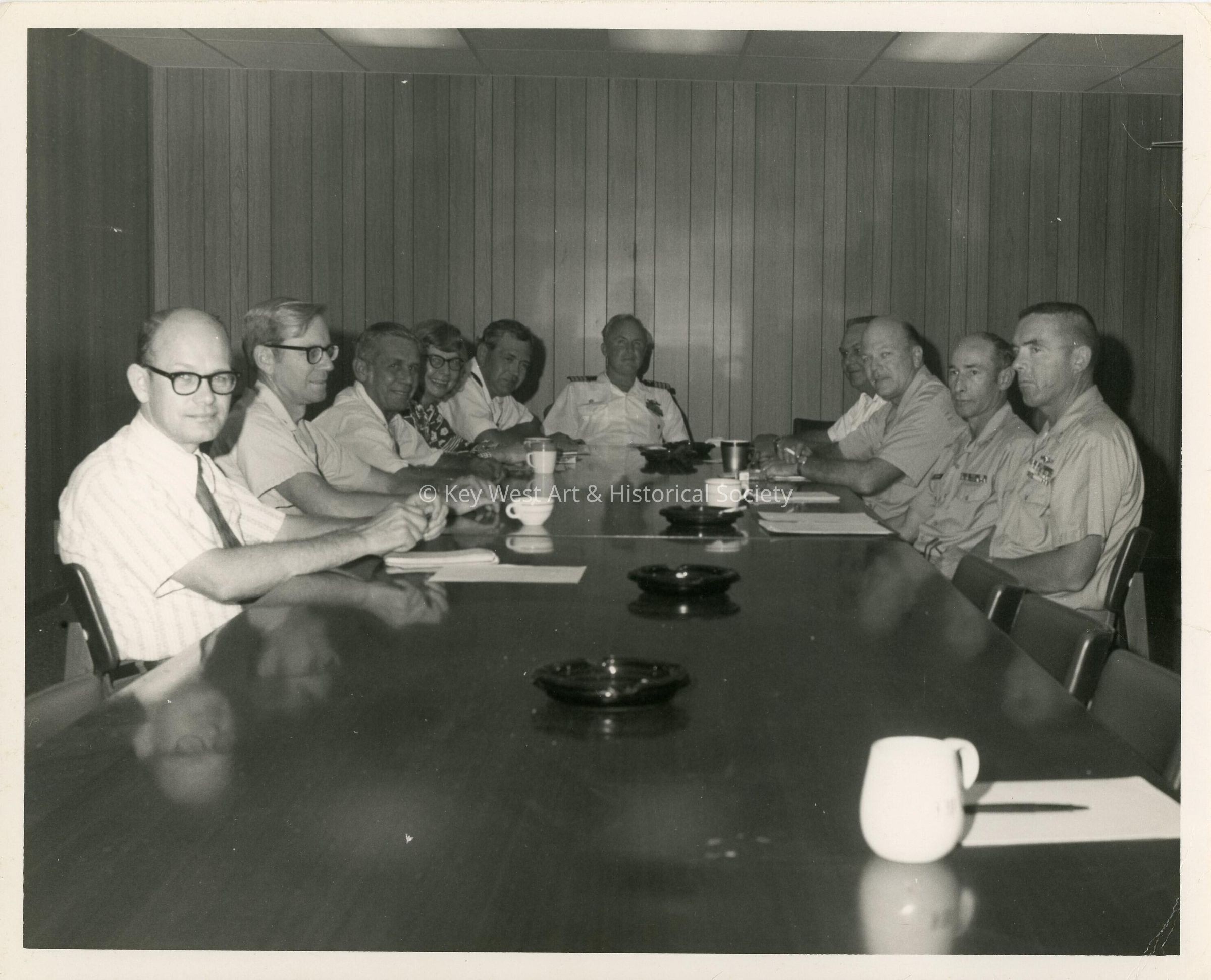 A group of unknown men sitting at a table