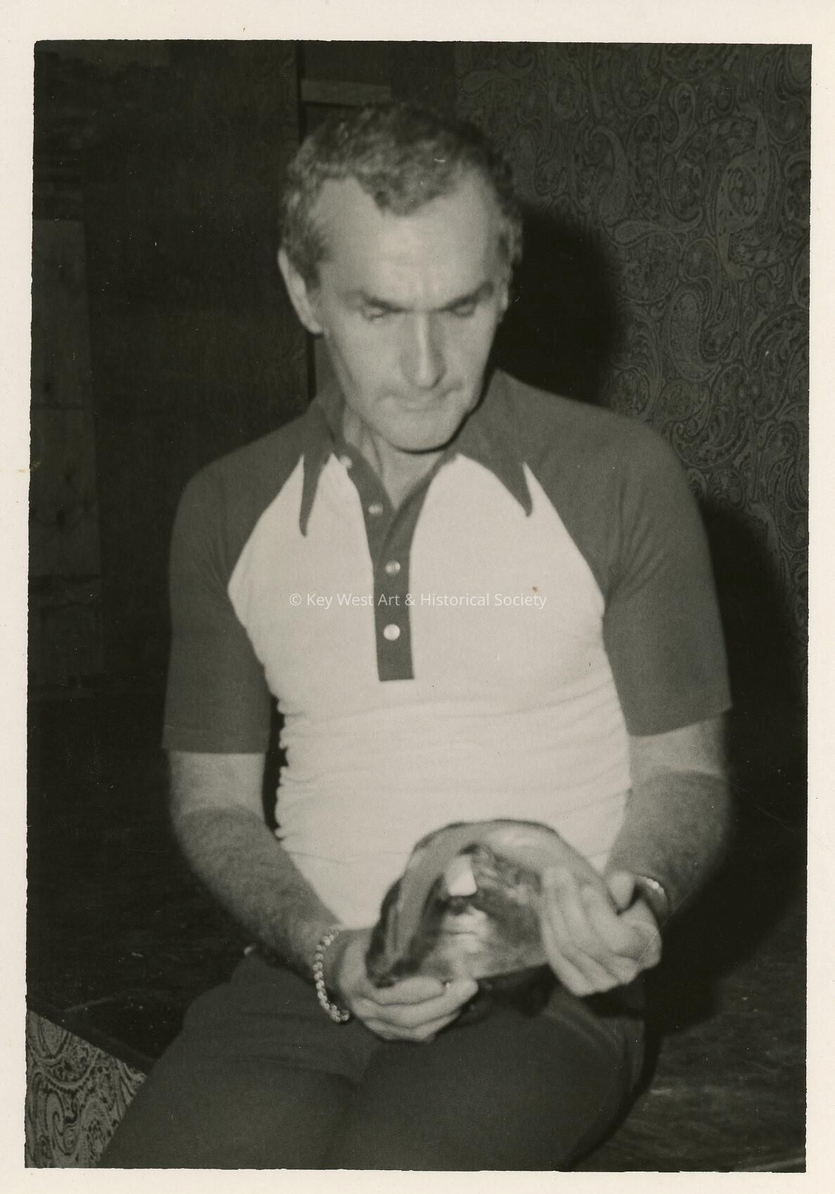 An unknown man holding an unknown object