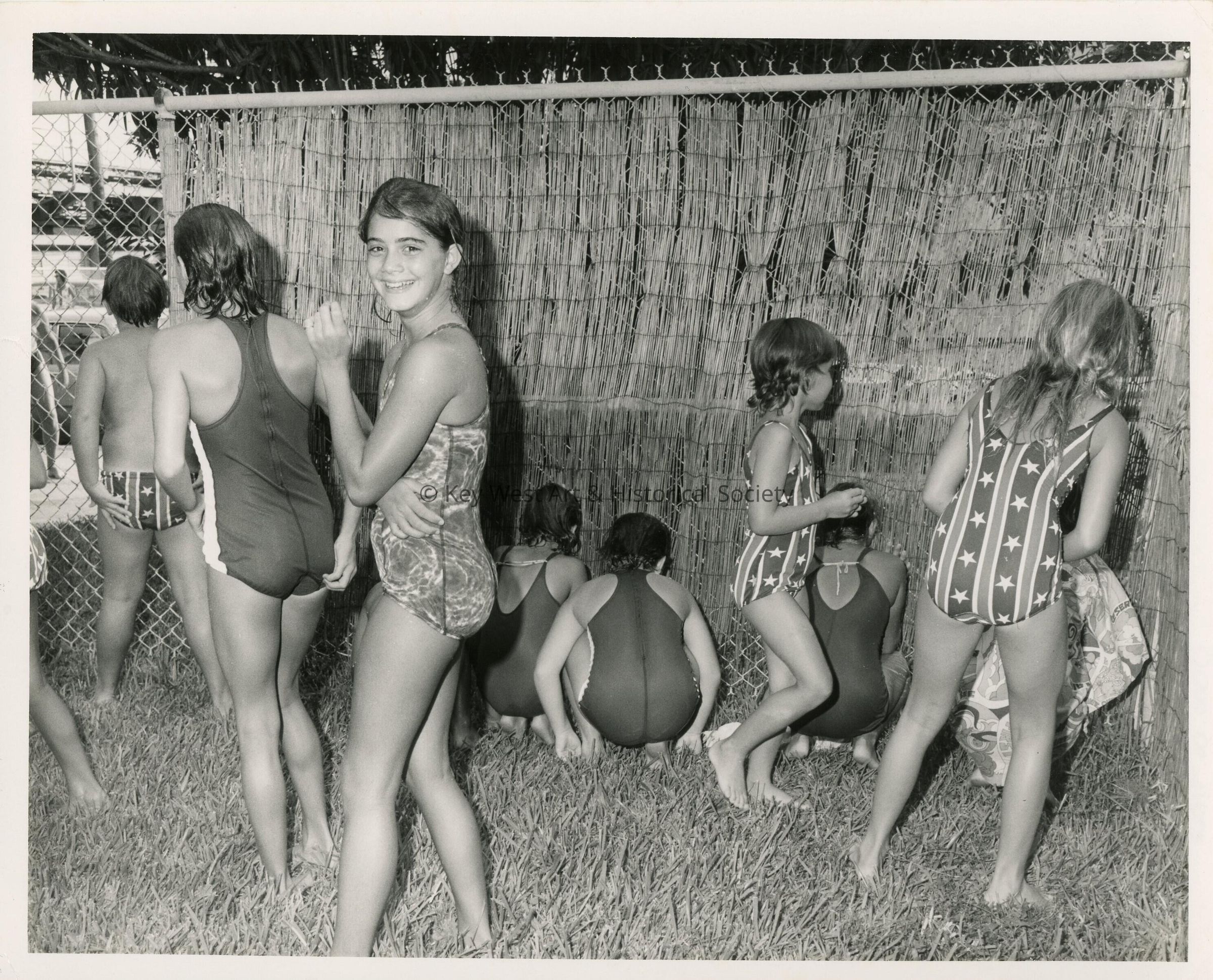 A group of unknown kids in a yard